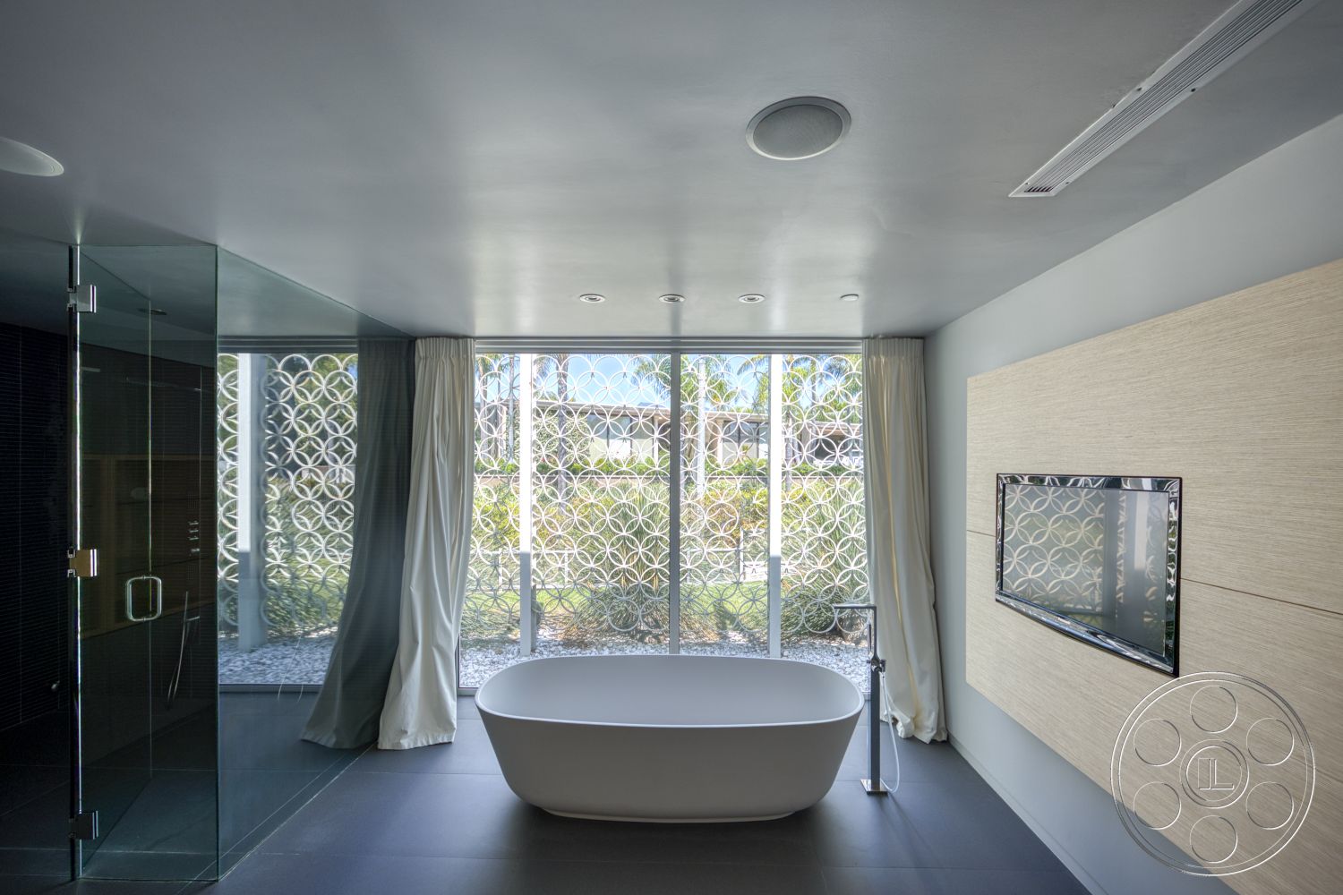 Modern 525 - neutral wall colors, freestanding bathtub, glass shower enclosure, minimalist design elements, floor-to-ceiling windows, textured wall paneling, modern ceiling lights, dark tile flooring, sheer curtain drapes, decorative privacy screen, mounted television