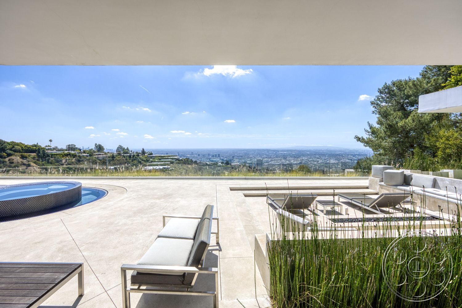 Modern 525 - exterior, modern architecture, minimalist design, glass railing, landscape view, rectangular pool, stone landscaping, concrete patio flooring, sunny hillside location, aluminum lounge chairs