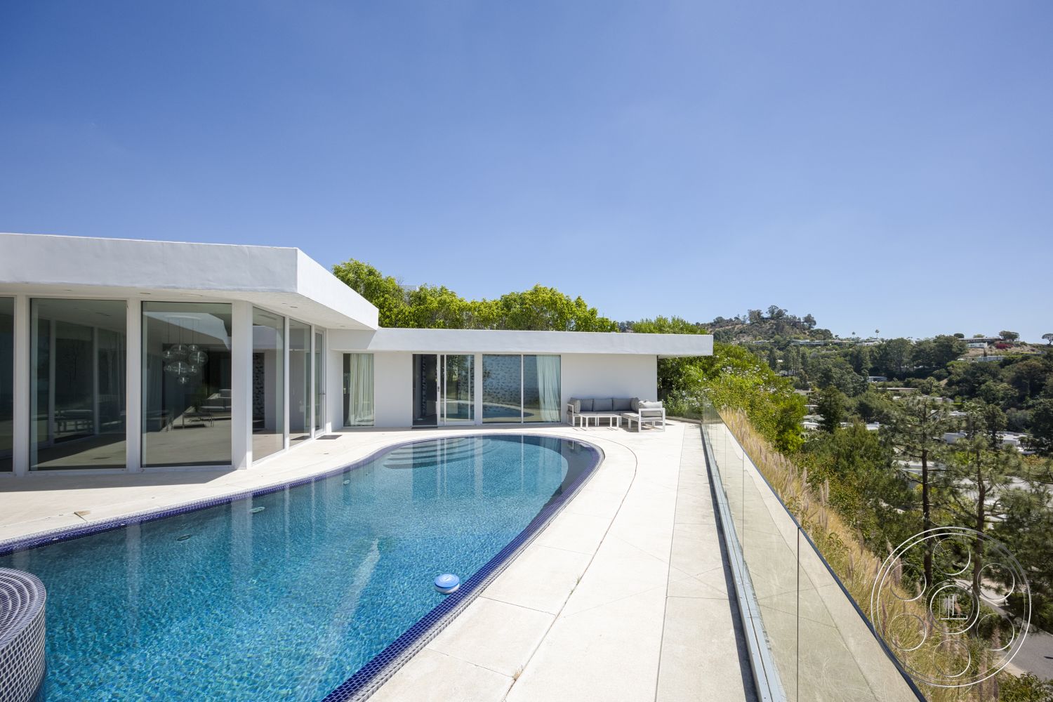 Modern 525 - exterior, white stucco walls, glass railing, floor-to-ceiling windows, concrete pool deck, rectangular pool, contemporary architectural style, open patio area, landscaped hillside setting
