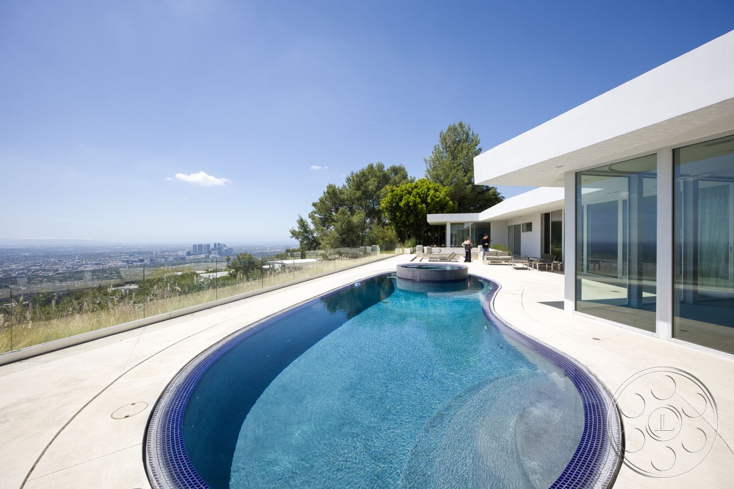 Modern 525 - exterior, glass railing, floor-to-ceiling windows, modern architectural style, patio seating area, concrete pool deck, lap pool, view of city skyline, curved swimming pool, flat roof design