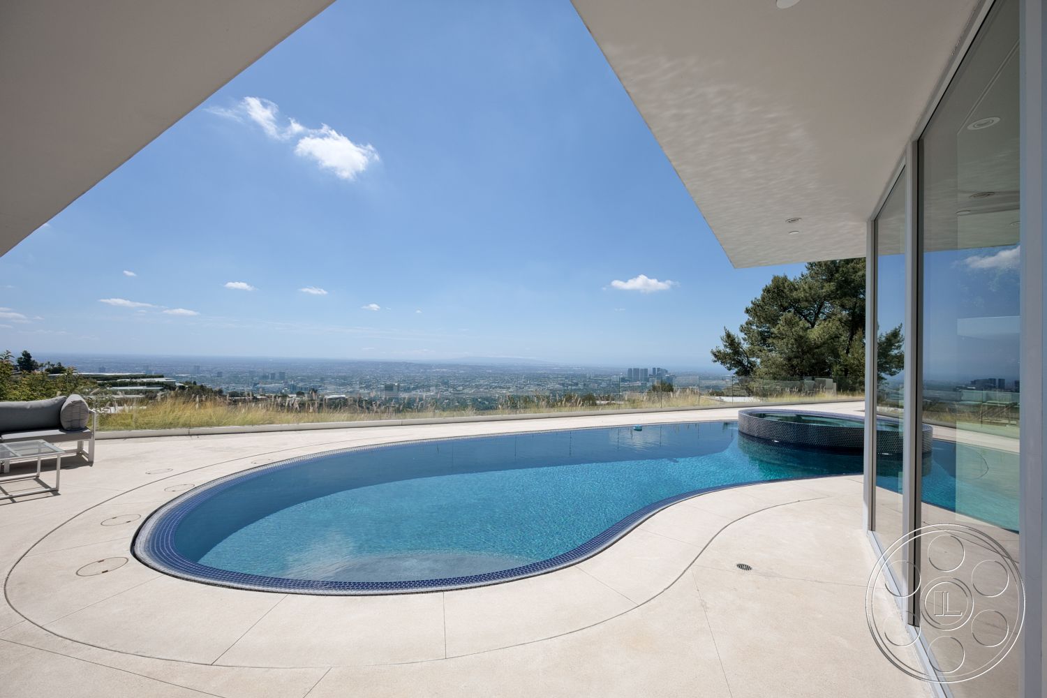 Modern 525 - exterior, modern architecture, minimalist design, floor-to-ceiling windows, infinity pool, curved pool shape, concrete patio flooring, glass partition walls, landscaped hillside setting, stunning city skyline view