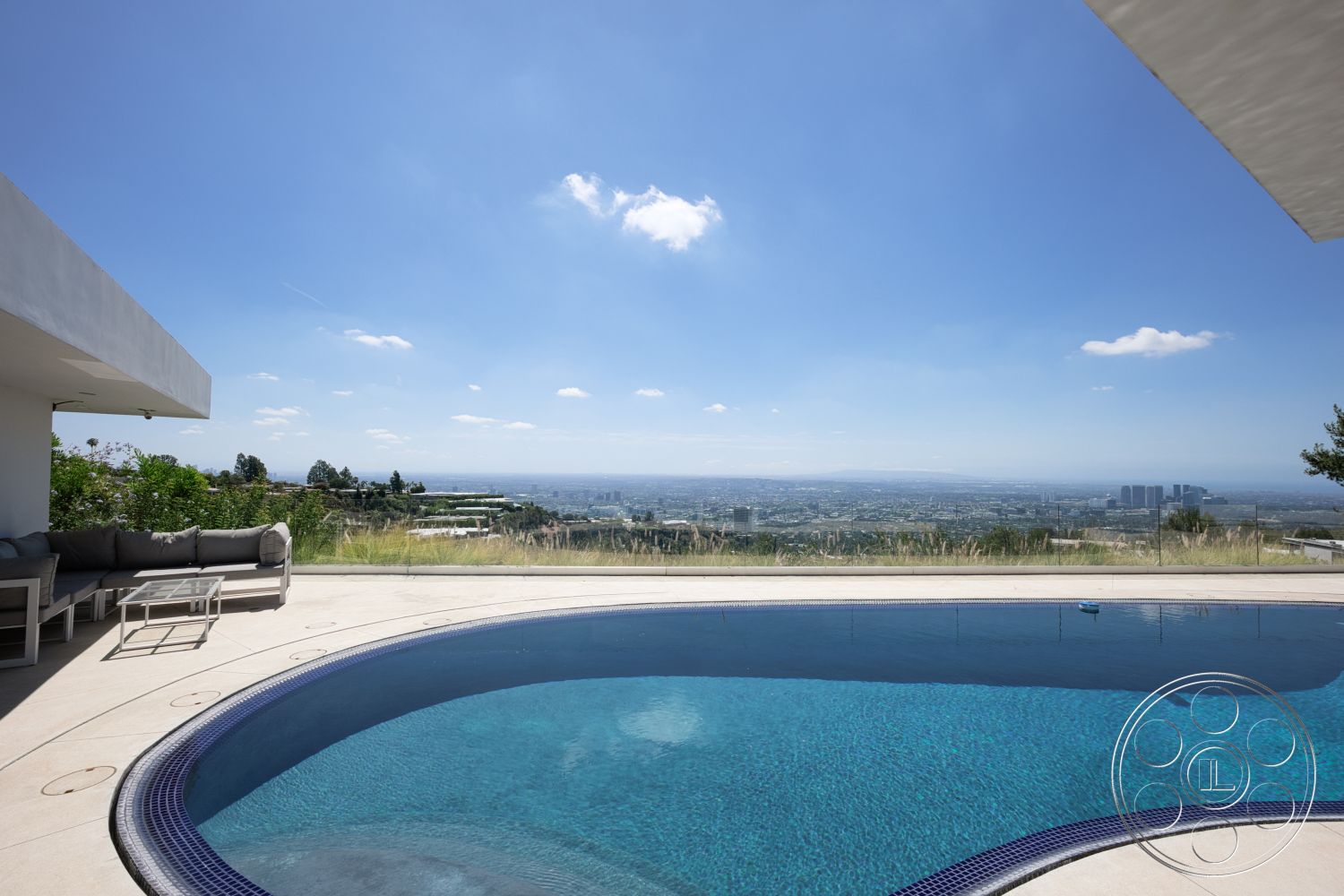 Modern 525 - glass railing, white stucco exterior, oval swimming pool, mountain view setting, landscaped garden area, minimalist outdoor furniture, concrete pool patio, interior outdoor lounge area, spacious outdoor deck