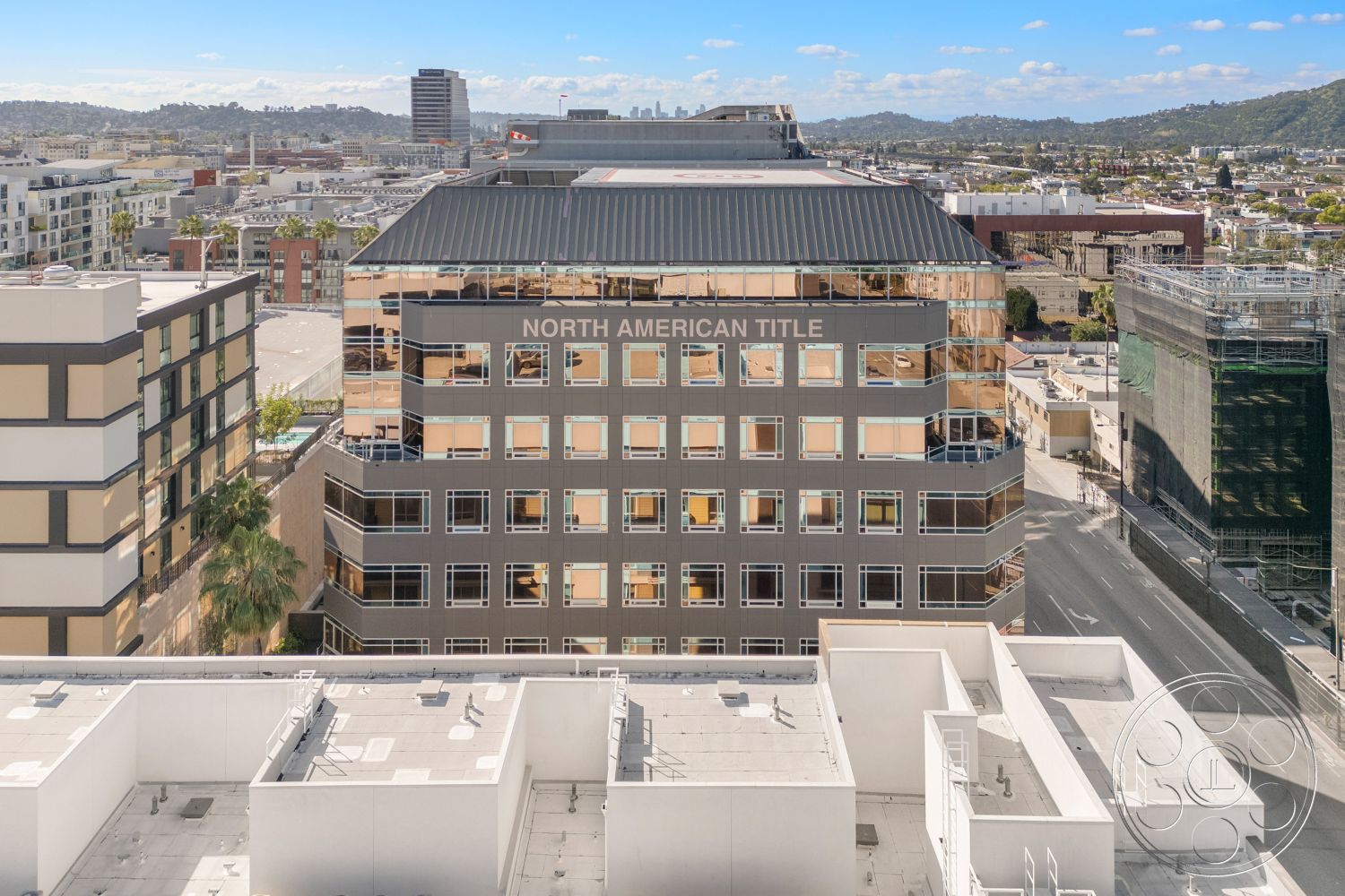 Rooftop-52 - exterior, urban setting, glass façade, city skyline view, metal roof, commercial architecture, brick wall accents, concrete sidewalk, flat roof design, aluminum window frames, rectangular office building