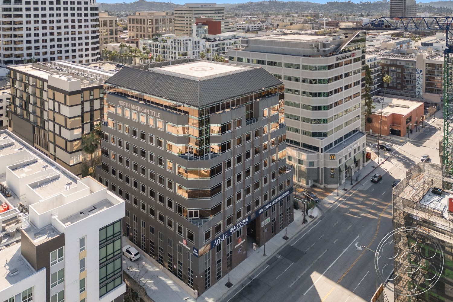 Rooftop-52 - exterior, modern architecture, paved road, urban environment, commercial district, concrete sidewalk, flat roof design, aluminum window frames, surrounding cityscape, landscape palm trees, architectural signage, multiple-story commercial building, steel and glass facade, bicycle lane indicator
