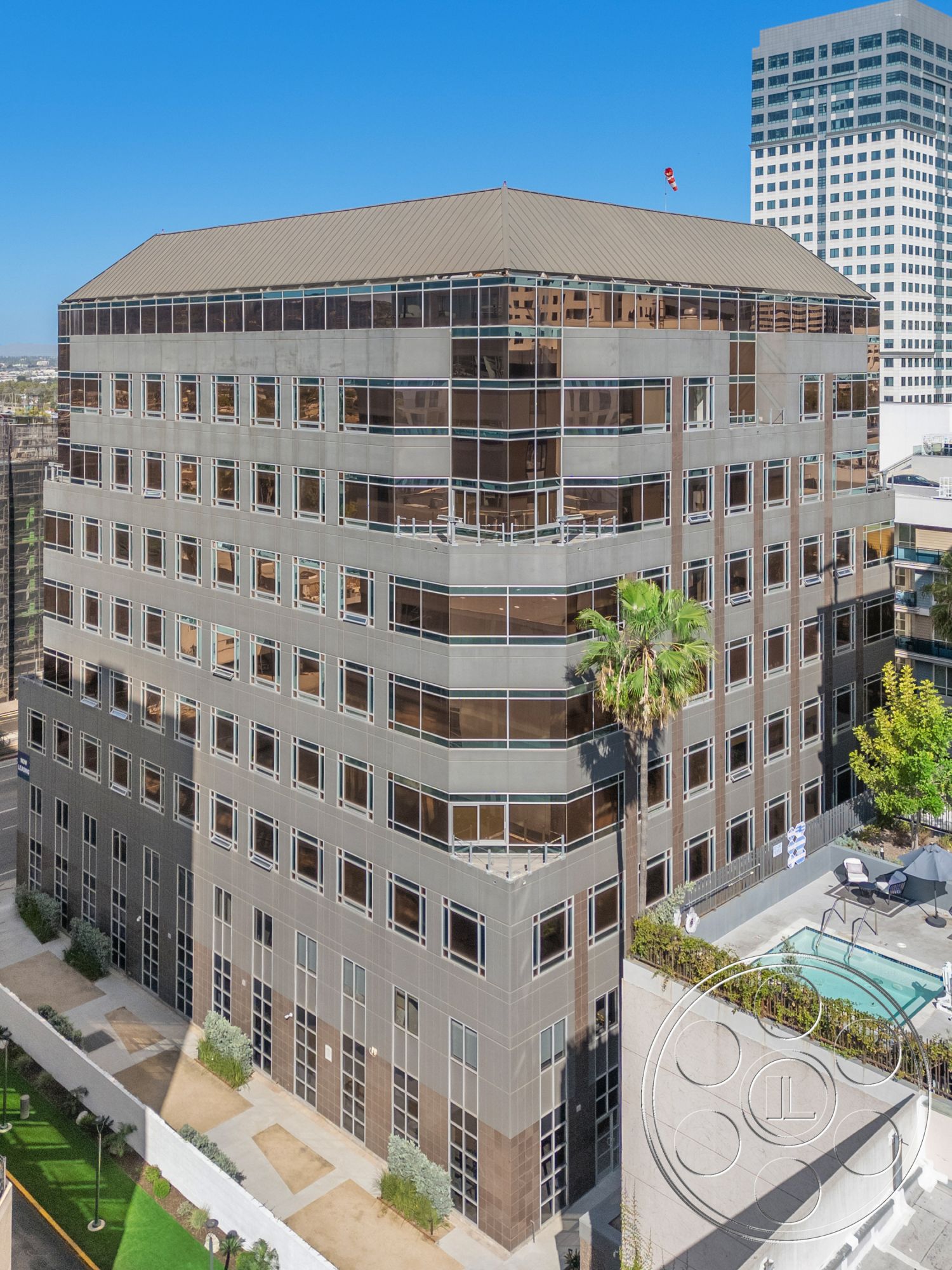 Rooftop-52 - surrounding greenery, floor-to-ceiling windows, urban environment, stone landscaping, glass curtain wall exterior, metal roof panels, exterior landscaping features, sloping rounded façades, modern office building, paved outdoor terrace