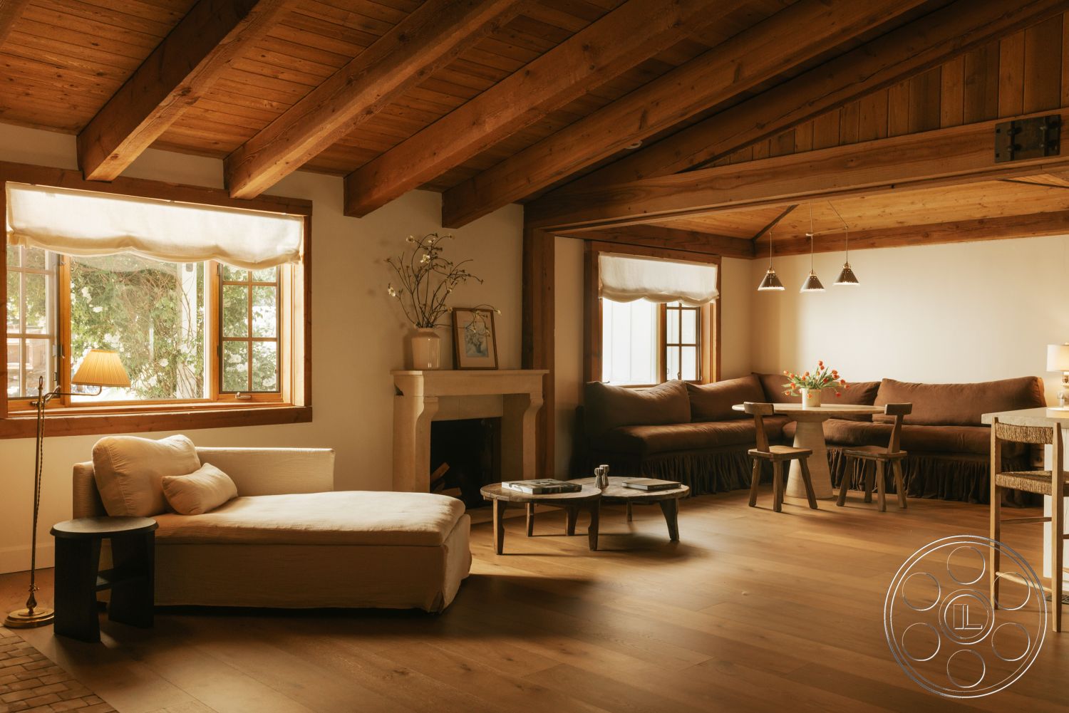 Modern-Farmhouse 20 - neutral color palette, cozy seating area, open concept design, floor-to-ceiling windows, plaster walls, wooden accent furniture, wood-framed windows, ambient lighting fixtures, exposed wood ceiling beams, hardwood living room floors, stone fireplace surround, rustic interior