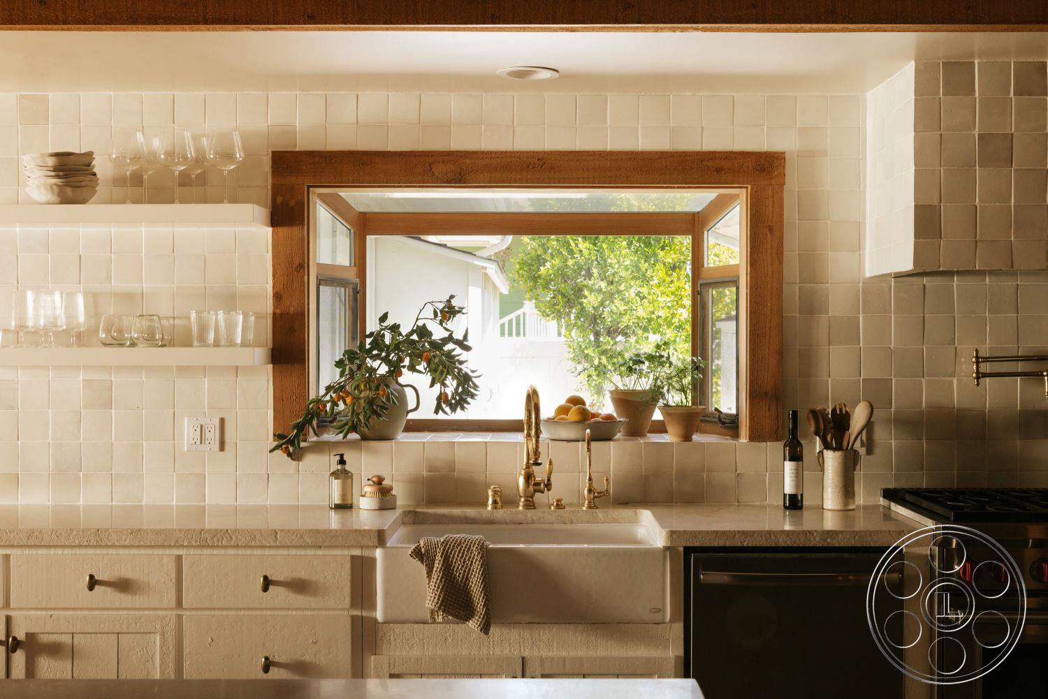 Modern-Farmhouse 20 - natural light from window, stainless steel kitchen appliances, open wood shelving, white shaker-style cabinets, white ceramic tile kitchen backsplash, exposed wood window frame, granite countertop sink area, bronze faucet fixtures, plant display on windowsill
