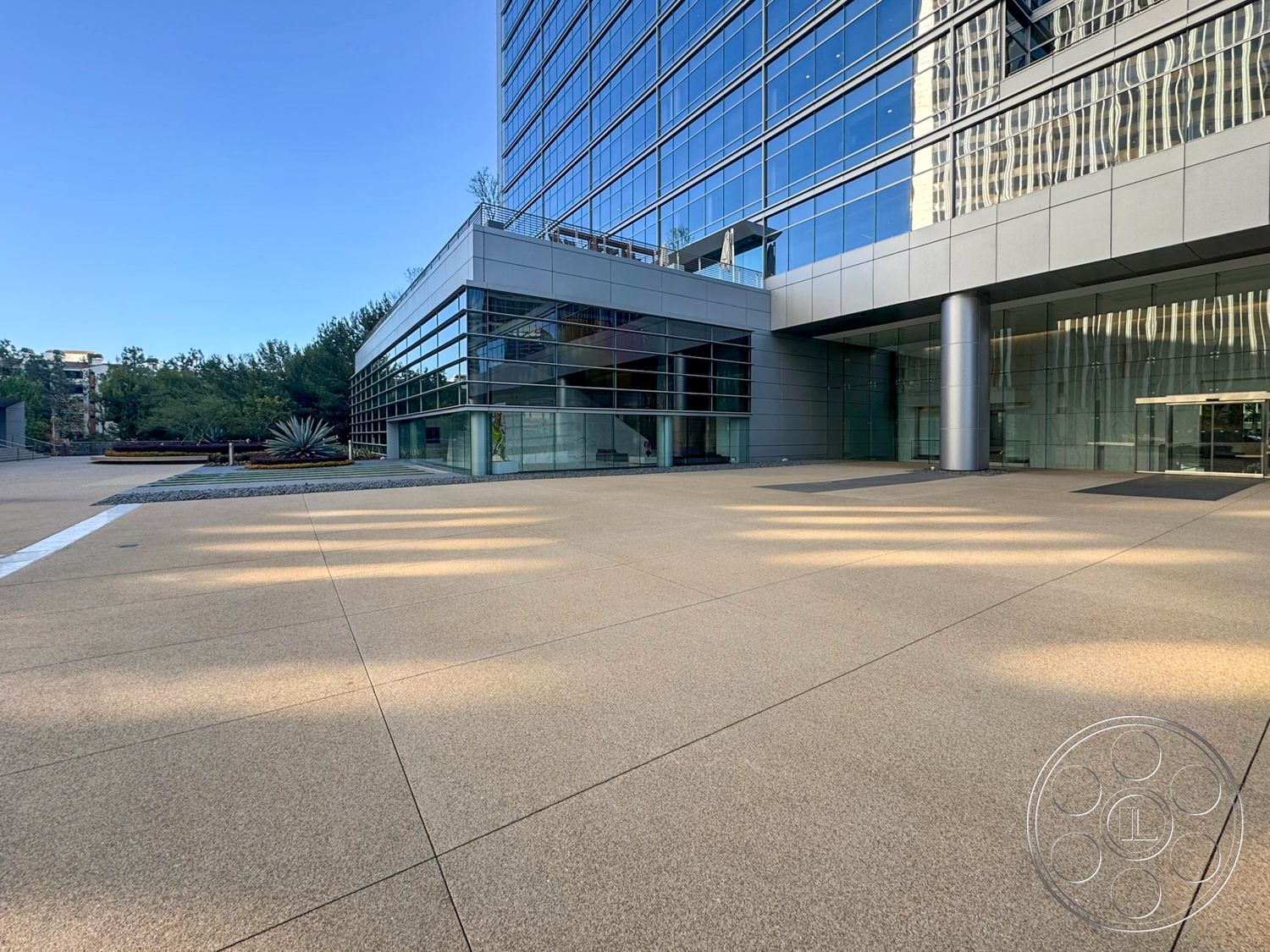 Ave Of The Stars - exterior, floor-to-ceiling windows, modern architectural style, landscaped garden area, integrated planters, glass curtain wall, concrete plaza flooring, metal panel facade, decorative gravel accent, polished concrete entrance, steel column details