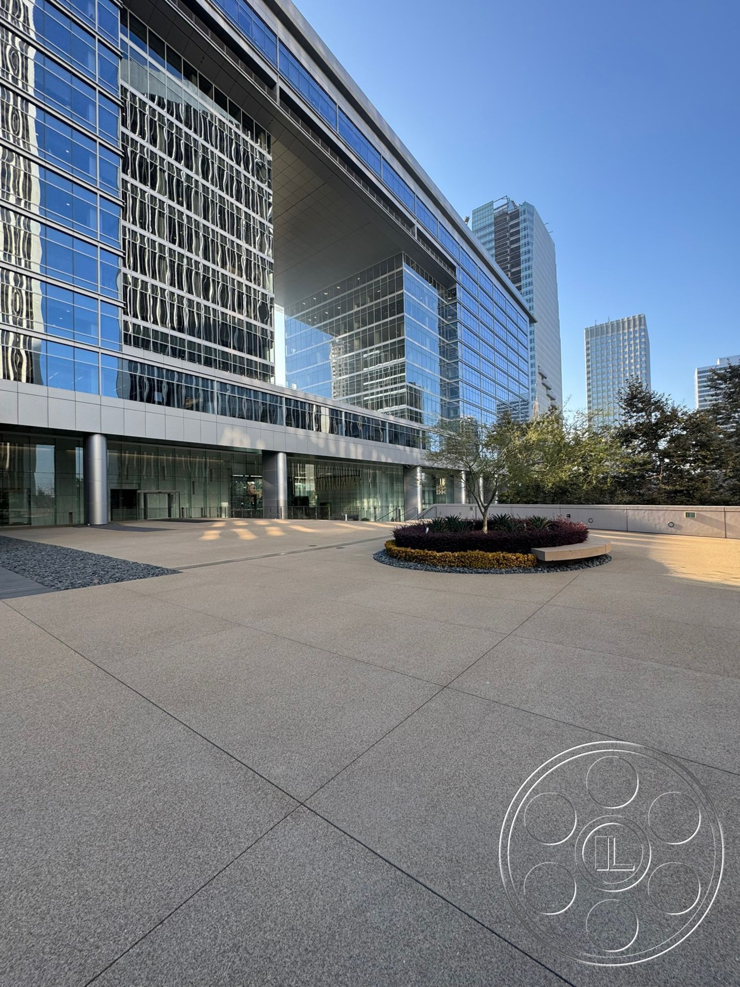 Ave Of The Stars - exterior, modern architecture, outdoor seating area, urban setting, floor-to-ceiling windows, glass facade, metal planter, landscaped garden bed, polished concrete walkway, river rock edging, steel building structure