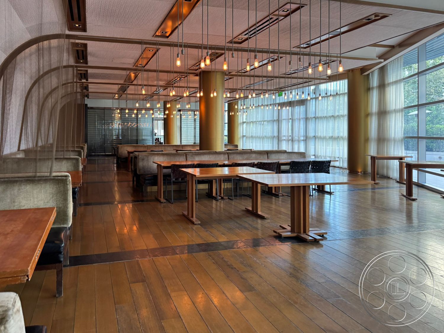 Ave Of The Stars - exposed ceiling structure, metal pendant lighting, glass curtain wall, modern open layout, wooden dining room floors, fabric upholstery seating, smooth wooden tabletops, vertical mesh partition, panelled walls