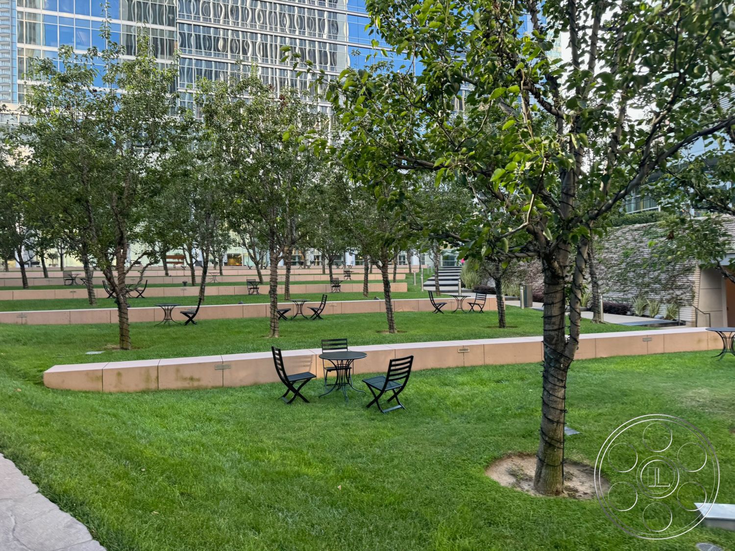 Ave Of The Stars - exterior, grass lawn, paved walkway, planted trees, metal outdoor furniture, stone wall feature, concrete landscaped seating areas, rectangular seating benches, modern urban park design, glass building facade reflection