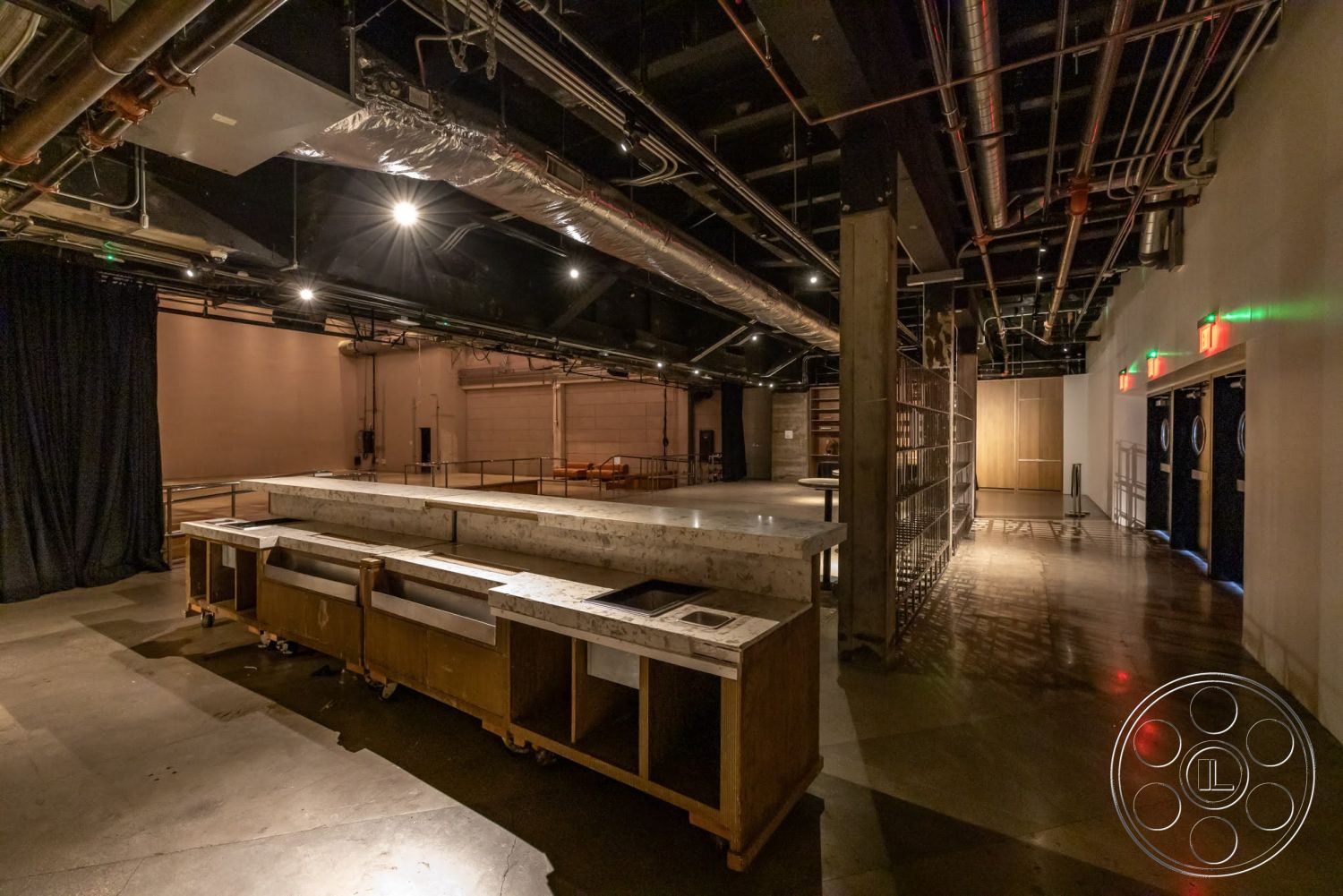 Sunset Campus - wood cabinetry, concrete flooring, floor-to-ceiling windows, exposed ductwork, built-in shelving units, steel support columns, modern architectural design, industrial style lighting, open layout space, black curtain wall, marble countertop bar