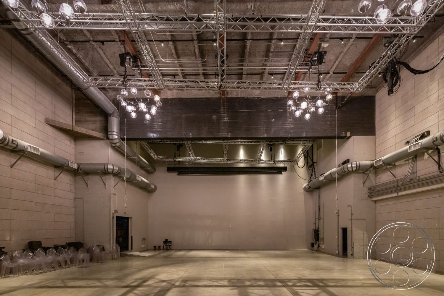 Sunset Campus - high ceilings, neutral color palette, open floor plan, polished concrete flooring, interior space, exposed concrete walls, industrial lighting fixtures, studio environment, modern industrial style, metal ceiling beams, ductwork ceiling design