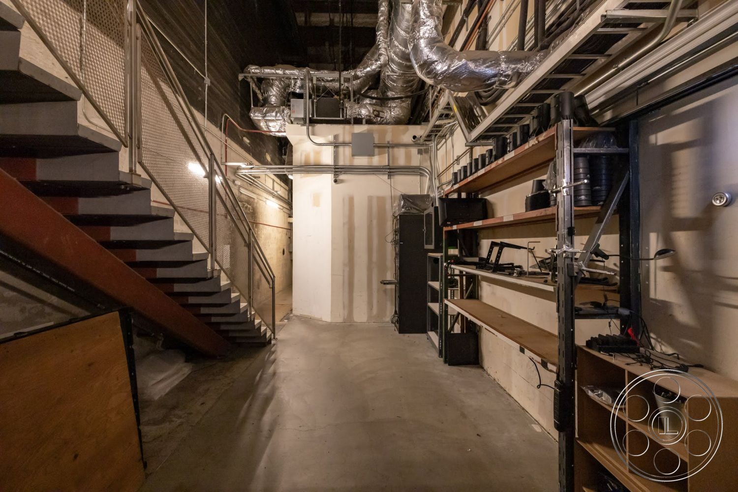Sunset Campus - wood shelving, concrete floor, interior space, metal railing, exposed ductwork, storage area, overhead lighting fixtures, industrial shelving, drywall walls, metal spiral staircase