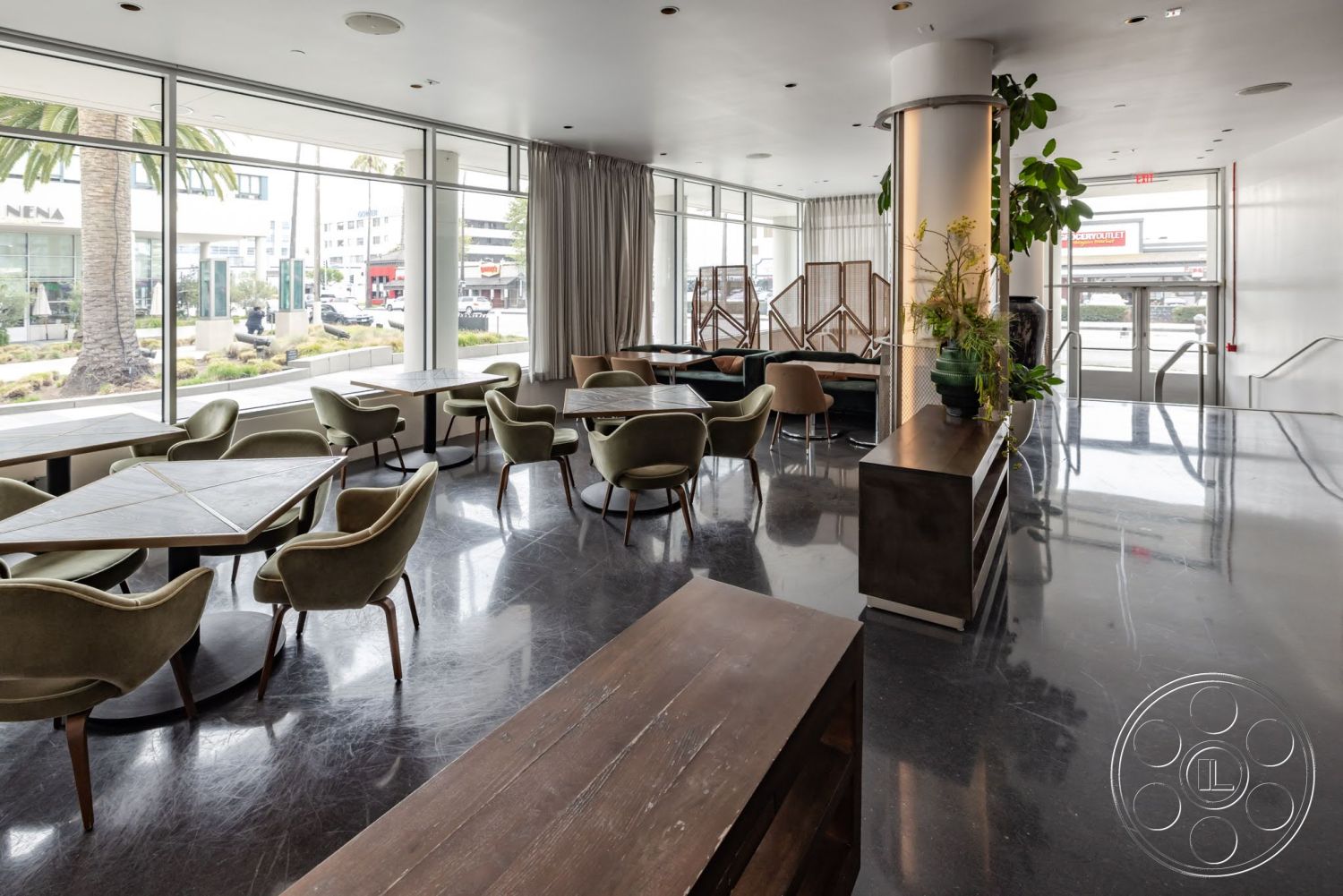 Sunset Campus - contemporary design, polished concrete flooring, minimalistic decor, urban setting, floor-to-ceiling windows, natural light filled space, soft fabric curtains, wood dining tables, curved velvet armchairs, modern decorative screens, metal plant stands