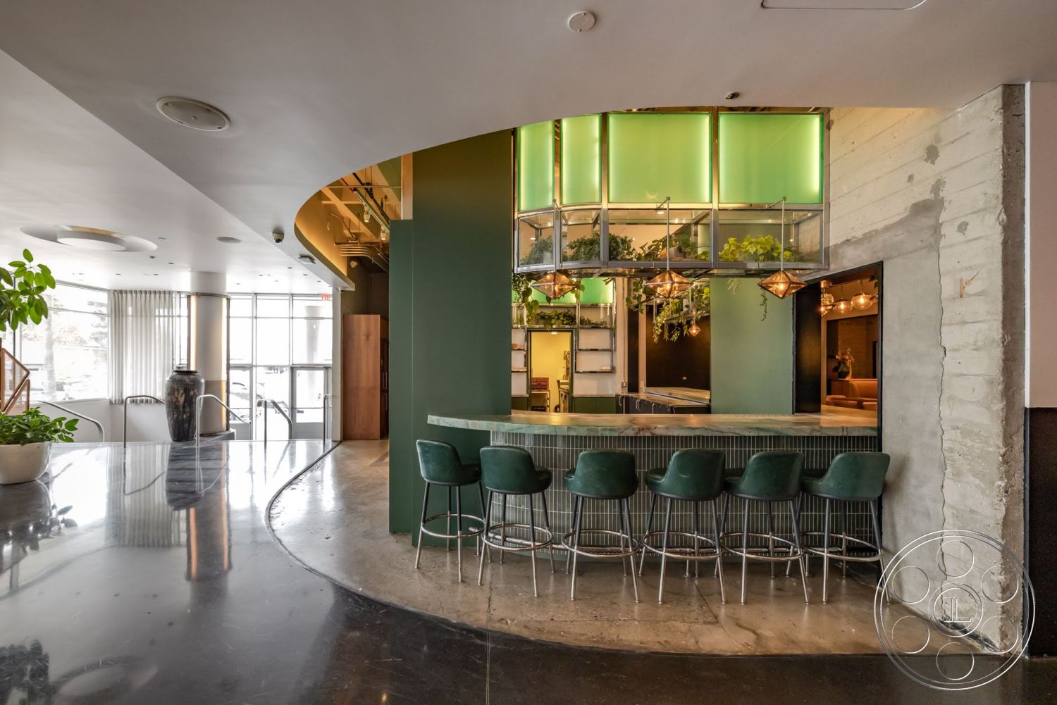 Sunset Campus - minimalist design, polished concrete floor, exposed concrete walls, botanical decor, ambient lighting fixtures, glass partition windows, rounded bar counter, green wall treatment, steel bar stools