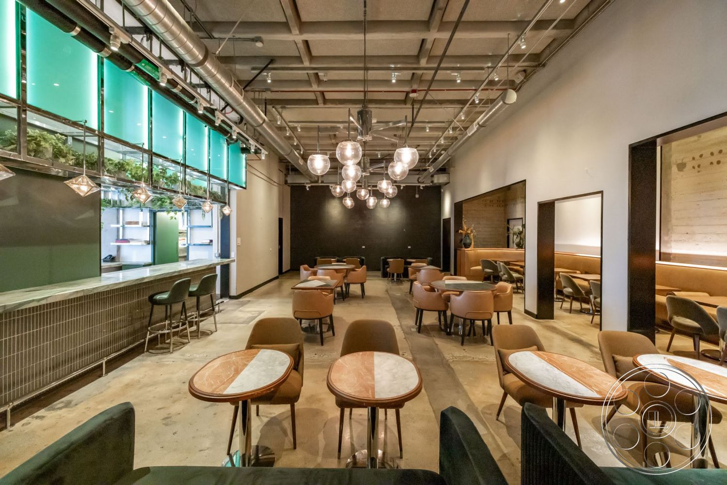 Sunset Campus - upholstered dining chairs, textured wall finish, hanging light fixtures, arched doorways, industrial-style décor, glass partition wall, exposed concrete flooring, modern bar seating, open ceiling with exposed ductwork, brick bar countertop, round wooden café tables, plant feature wall, green accent wall paneling