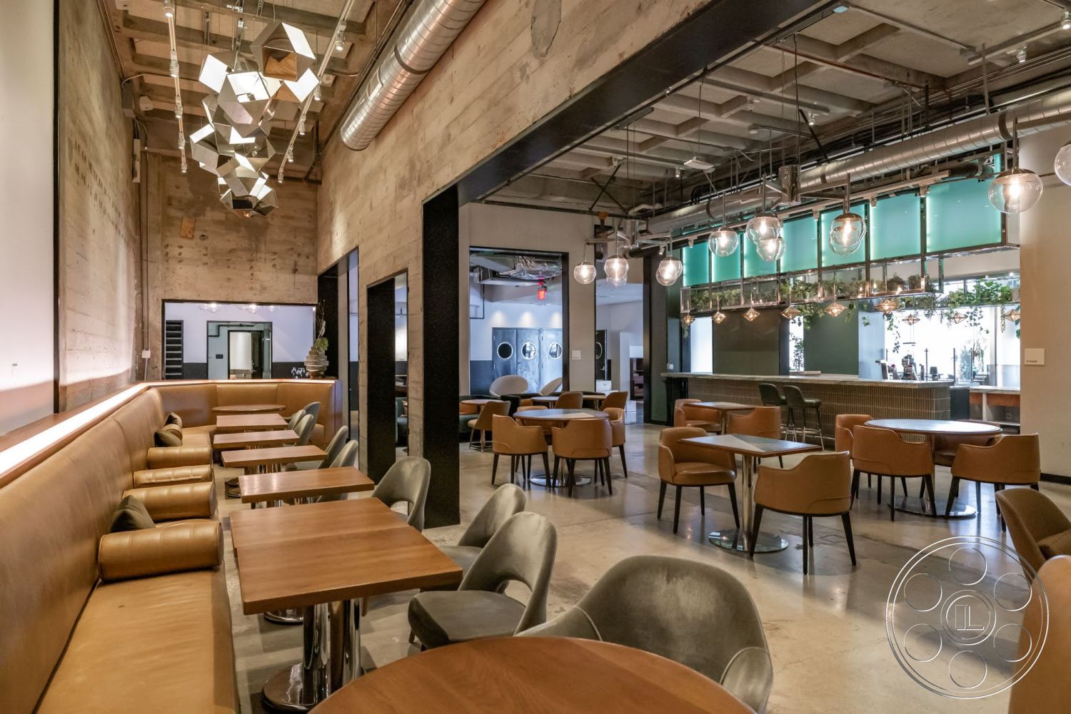 Sunset Campus - exposed concrete walls, modern industrial design, wood laminate flooring, minimalist interior, leather upholstered seating, concrete ceiling with grid pattern, metal café tables, pendant light fixtures with geometric shapes, glass bar front, tiled bar back with mosaic pattern, green glass window panels