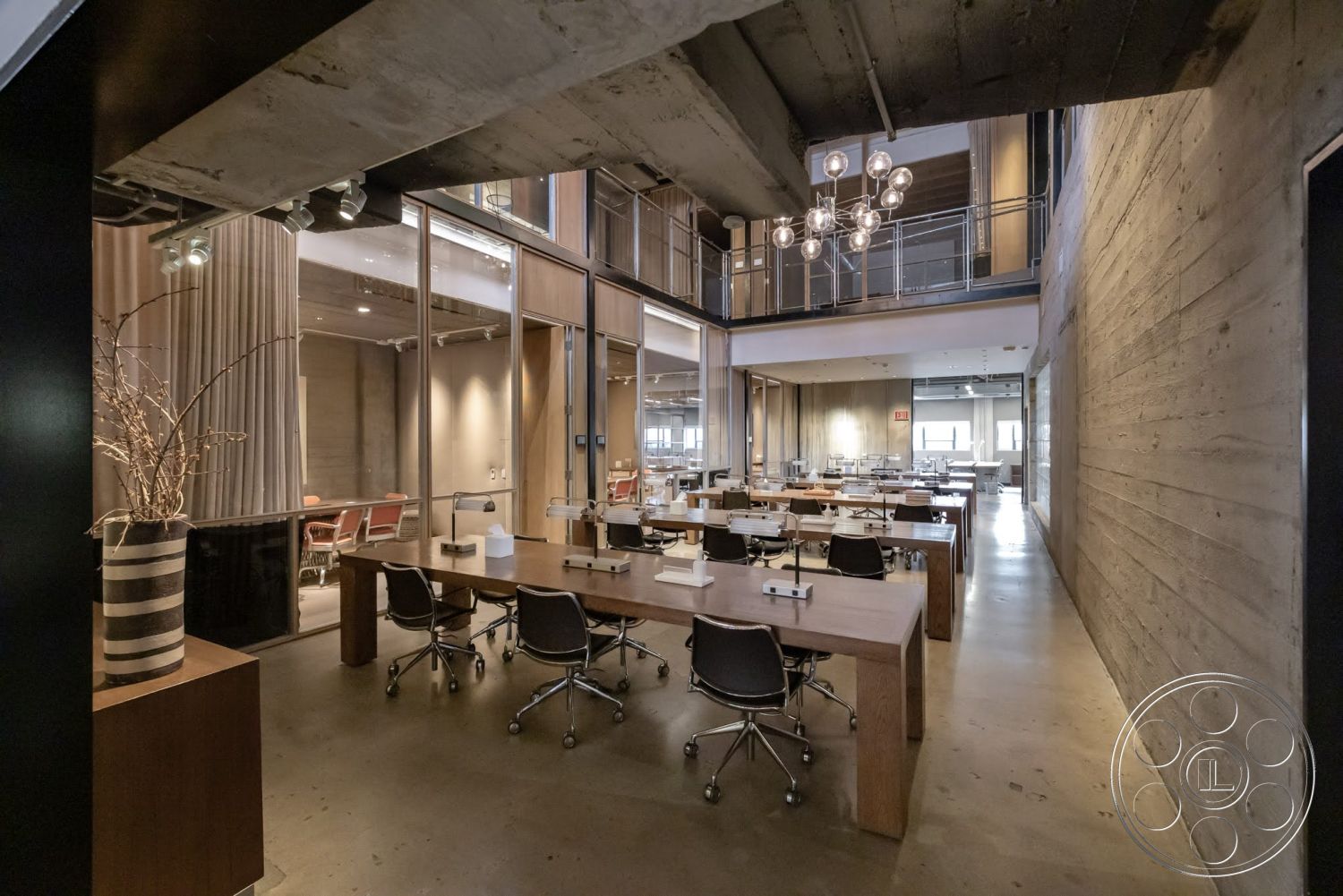 Sunset Campus - polished concrete flooring, exposed concrete walls, light wood ceiling beams, glass partition walls, modern office space, metal office chairs, open concept office layout, industrial style lighting fixtures, wood conference tables