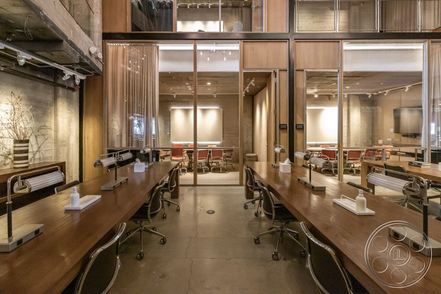 Sunset Campus - neutral color palette, contemporary design, open floor plan, concrete floor, textured concrete walls, modern workspace, exposed wood ceiling beams, glass partition walls, functional workstations, metal office chairs, industrial style lighting, collaborative office area, wood desk surface, curtained room divider