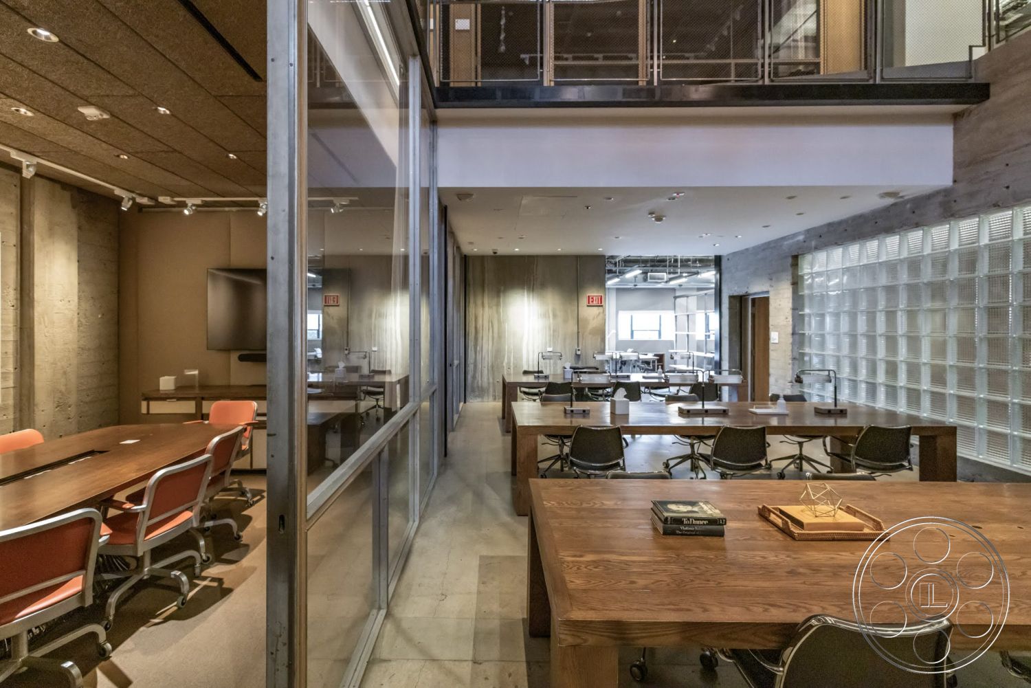 Sunset Campus - polished concrete flooring, exposed concrete walls, floor-to-ceiling windows, suspended ceiling lights, glass partition walls, metal stair railings, modern office design, wood paneling accent wall, rectangular conference table, industrial-style ceiling, multifunctional workspace, open workspace area, steel and glass interior