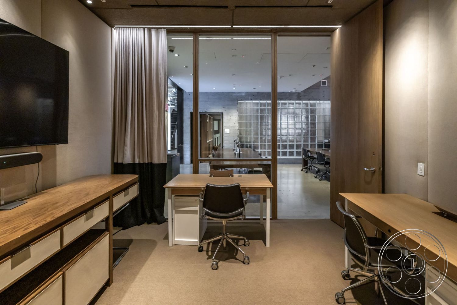 Sunset Campus - minimalist design, floor-to-ceiling windows, exposed ceiling, dark wood paneling, black office chairs, contemporary lighting fixtures, textured plaster wall, soft carpet flooring, modern office space, glass partition wall, wood desk with metal legs, dual workspace setup, curtains with contrasting colors