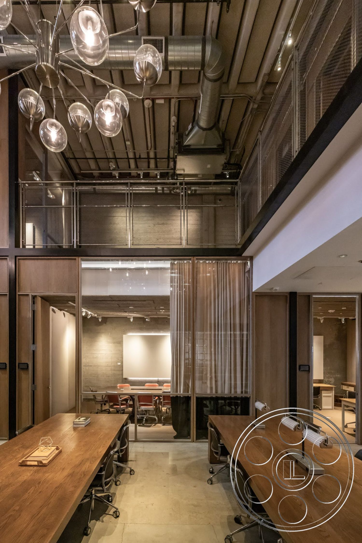 Sunset Campus - concrete flooring, modern pendant lighting, exposed concrete walls, industrial style, open office layout, glass partition walls, brightly lit workspace, metal ceiling beams, soft fabric curtains, wood conference tables, mesh metal railing, stylish task chairs, large presentation screen