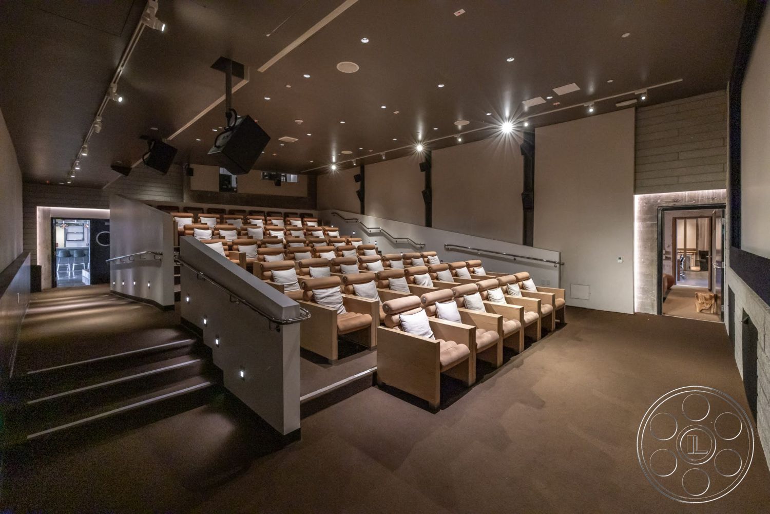 Sunset Campus - recessed lighting, carpet flooring, wooden handrails, dark wall finishes, contemporary interior style, modern theater design, acoustic wall panels, home theater seating, multiple tiered seating, integrated sound systems, luxury cinema chairs