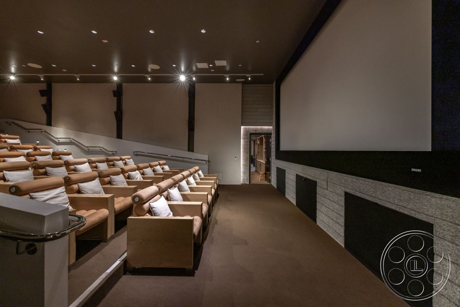 Sunset Campus - neutral color palette, carpet flooring, wood paneling accents, dimmed lighting fixtures, exposed structural beams, acoustic wall treatment, projector screen wall, built-in sound system, theater room, dark ceiling treatment, reclining lounge chairs, cinema seating