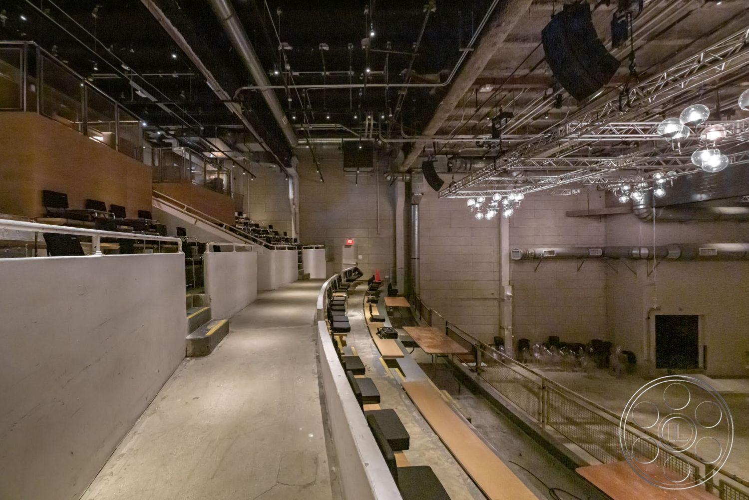 Sunset Campus - exterior, concrete floor, modern lighting fixtures, concrete walls, industrial style, exposed ductwork, steel railings, theater room, wood seating platforms