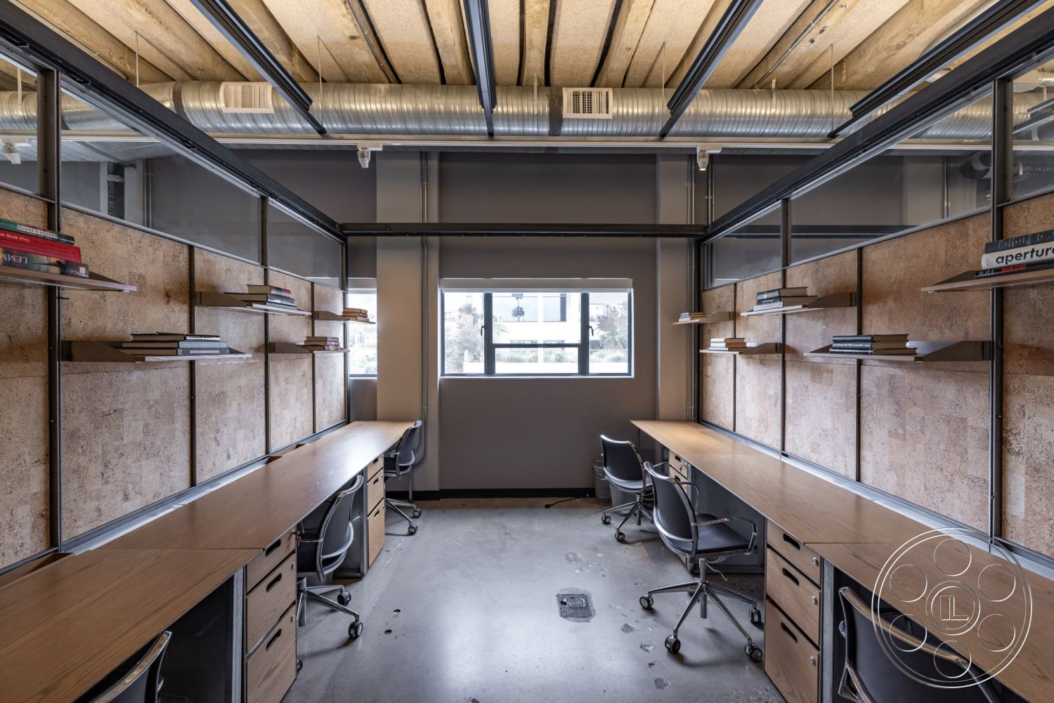 Sunset Campus - minimalist design, metal shelving units, natural light from windows, exposed concrete floor, open office layout, glass partition walls, wooden office desks, modern office chairs, horizontal wood panel wall treatment, industrial-style ceiling with exposed ductwork