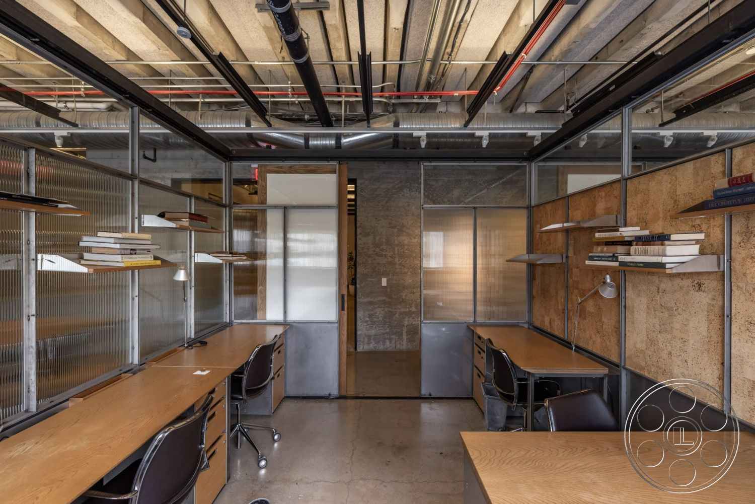 Sunset Campus - concrete flooring, task lighting, steel framing, exposed ceiling beams, glass partition walls, minimalist office design, wooden desk surfaces, cork wall treatment, metal desk hardware