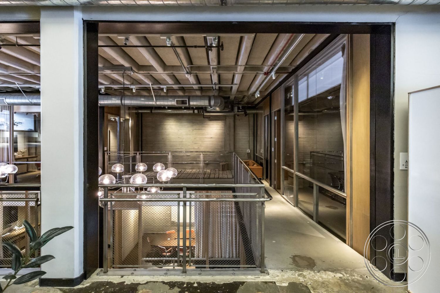 Sunset Campus - neutral color palette, recessed lighting, polished concrete floor, modern design, open floor plan, exposed concrete walls, metal railing, industrial lighting fixtures, urban loft, wood ceiling beams, glass partition walls, steel ductwork