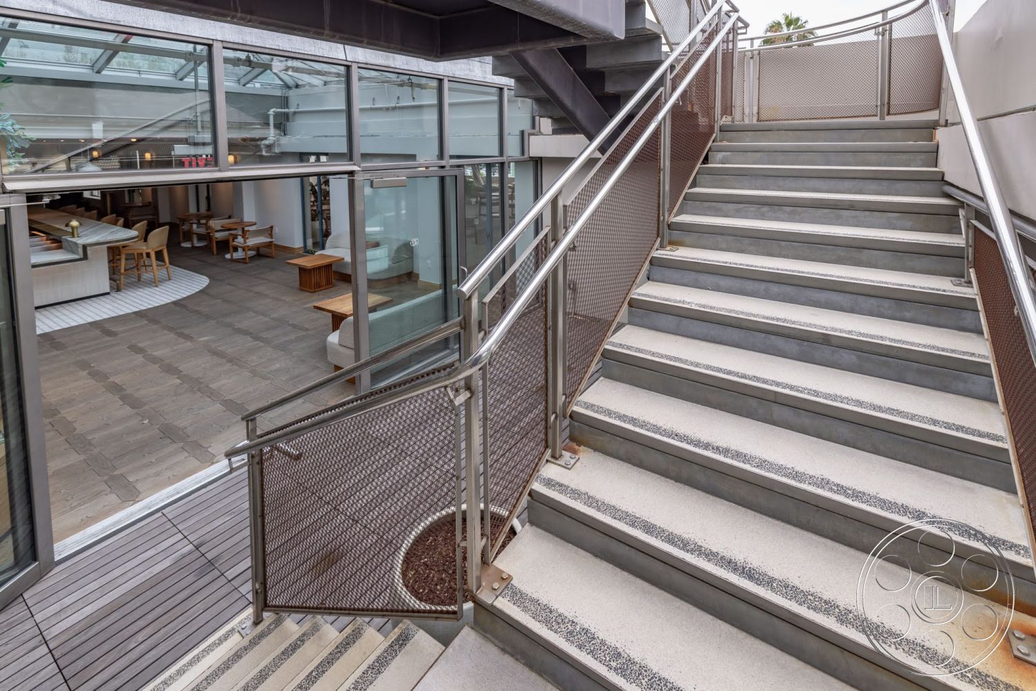 Sunset Campus - exterior, open floor plan, concrete steps, industrial design elements, modern architectural style, wood deck, glass wall panels, metal stair railing, slate patio flooring, exposed steel structure
