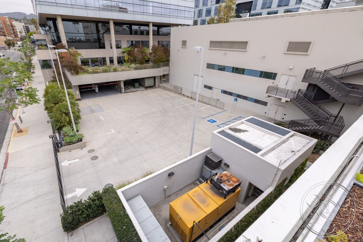 Sunset Campus - exterior, open space layout, landscaped greenery, concrete walls, urban setting, planter boxes, steel staircase, glass curtain wall, concrete parking lot surface, service area with generator, multistory building design, commercial building architecture
