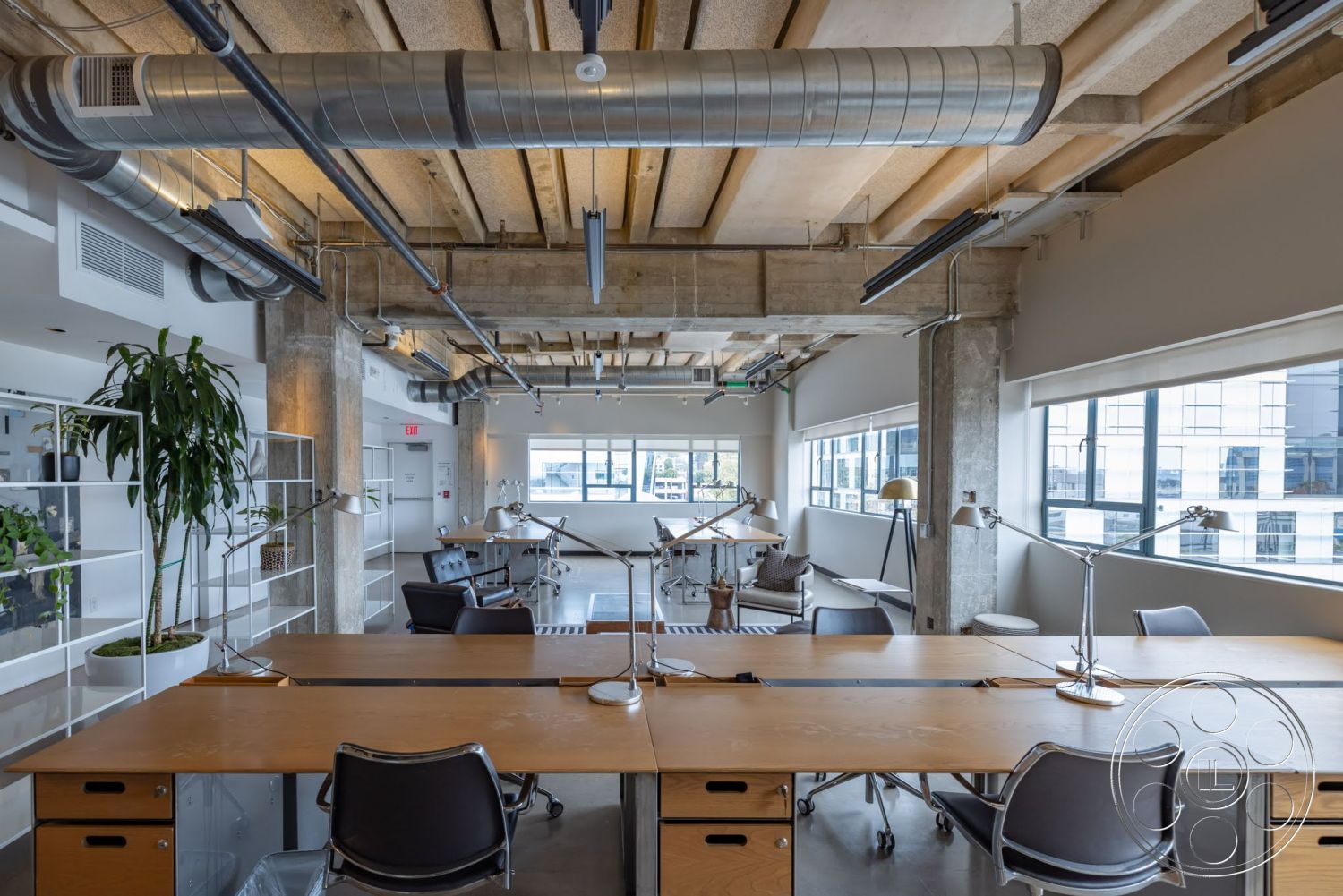 Sunset Campus - large windows, polished concrete flooring, functional workspace, wooden ceiling beams, planter with greenery, metal ductwork, contemporary lighting fixtures, workspace layout, glass partition walls, modern office furniture, exposed concrete columns, industrial style decor, open ceiling design