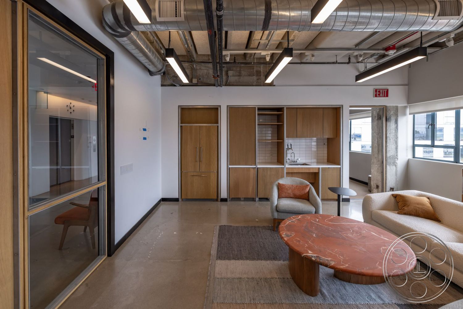 Sunset Campus - textured area rug, polished concrete flooring, ambient lighting, marble coffee table, ceramic tile backsplash, wood frame windows, modern kitchen cabinetry, open floor plan design, contemporary lounge seating, exposed ceiling with metal ductwork, natural wood veneer cabinets, soft upholstered sofa