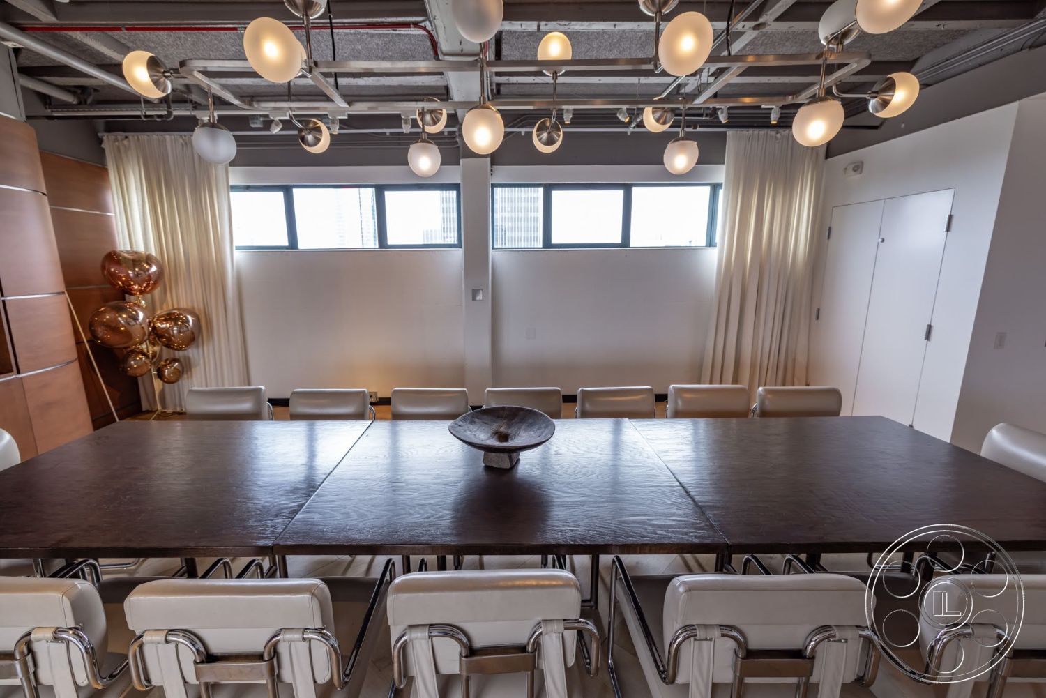 Sunset Campus - neutral color palette, large windows, minimalist design, urban setting, modern dining room, concrete ceiling, dark wood dining table, transparent curtains, metal dining chairs, wood panel accent wall, LED pendant lighting