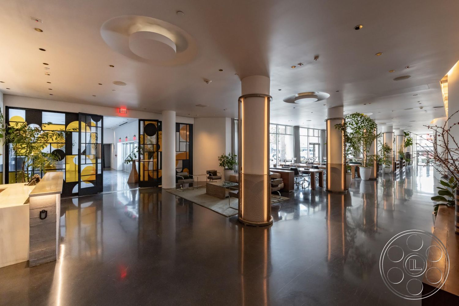 Sunset Campus - polished concrete flooring, textured wall panels, glass wall partitions, decorative indoor plants, exposed ceiling lights, large windows with natural light, open seating area, modern lounge furniture, curved ceiling features, modern decorative pillars, artistic glass door design, reception area layout