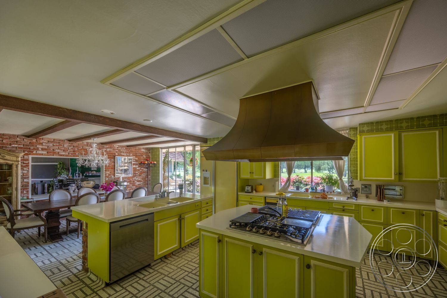 Euphoria - floor-to-ceiling windows, contemporary kitchen design, exposed brick accent wall, white quartz kitchen countertops, open concept interior, hardwood dining room floors, green laminate kitchen cabinets, octagonal tile kitchen flooring, metal chimney hood, chandelier dining room lighting, brightly colored kitchen