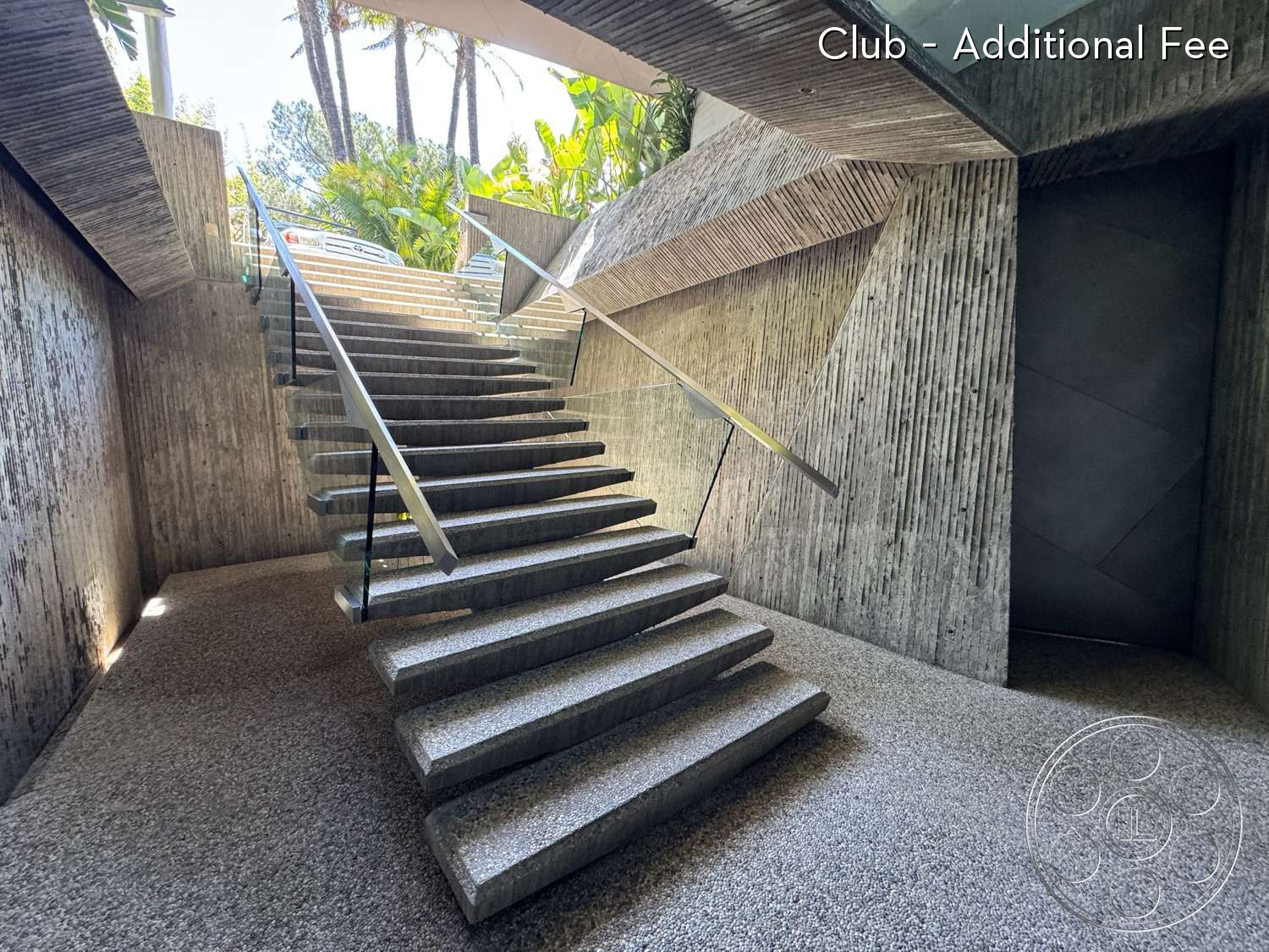Goldstein House - concrete stairs, modern architectural style, textured concrete walls, landscaped outdoor view, exposed aggregate flooring, glass stair railings, natural light from upper level