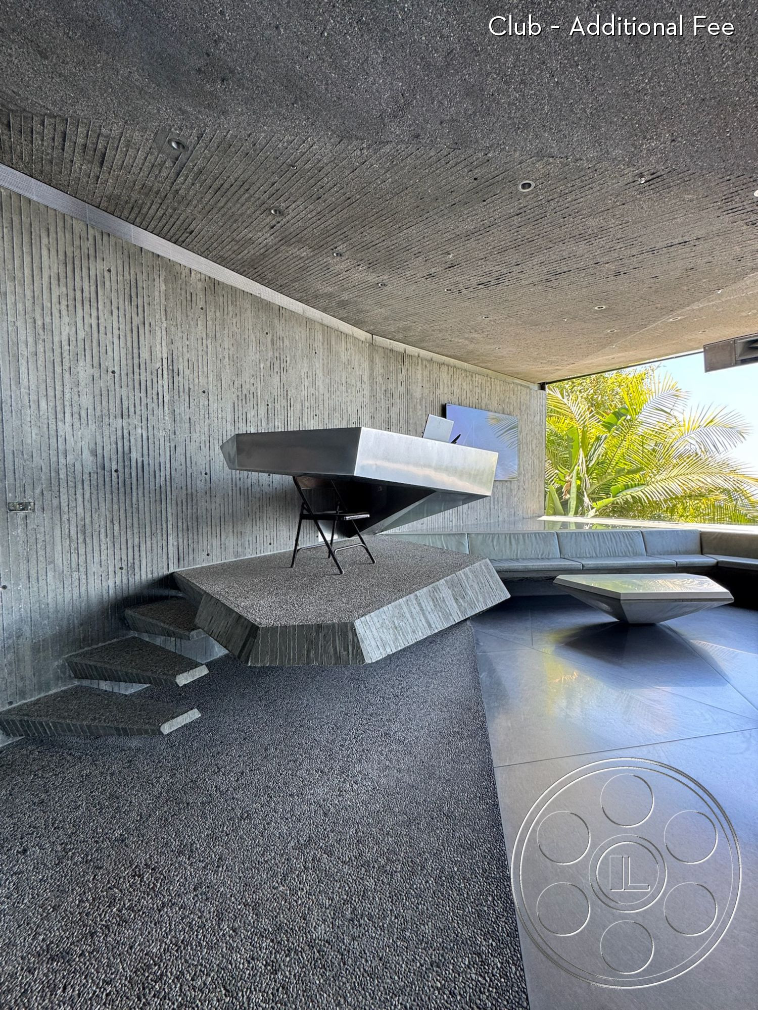 Goldstein House - open floor plan, minimalist design, polished concrete floor, floor-to-ceiling windows, exposed concrete walls, outdoor garden view, contemporary interior, textured concrete ceiling, sculptural furniture design, geometric architectural forms, cantilevered concrete table, angular seating area, indoor/outdoor integration