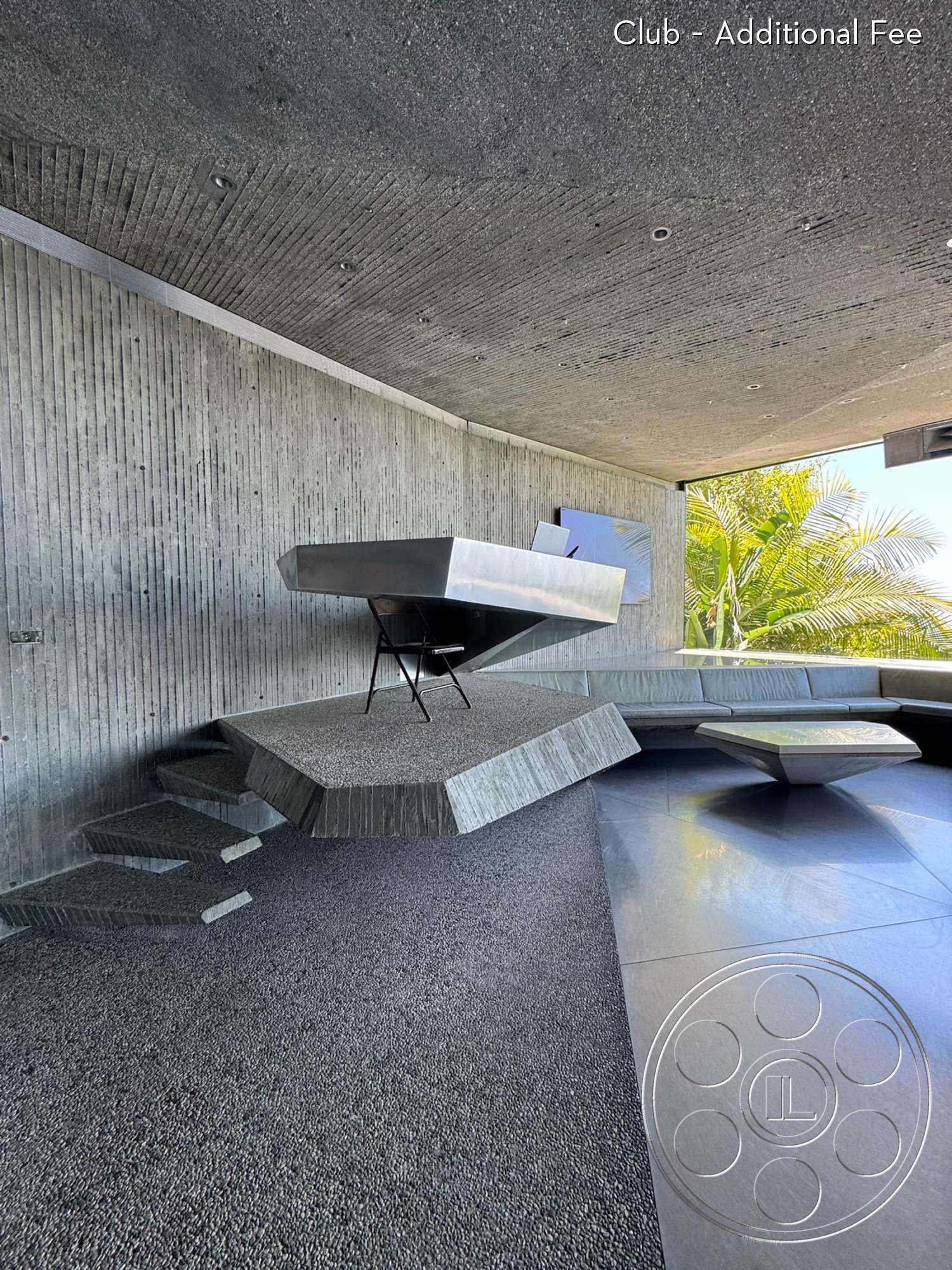Goldstein House - open floor plan, minimalist design, polished concrete floor, floor-to-ceiling windows, exposed concrete walls, outdoor garden view, contemporary interior, textured concrete ceiling, sculptural furniture design, geometric architectural forms, cantilevered concrete table, angular seating area, indoor/outdoor integration