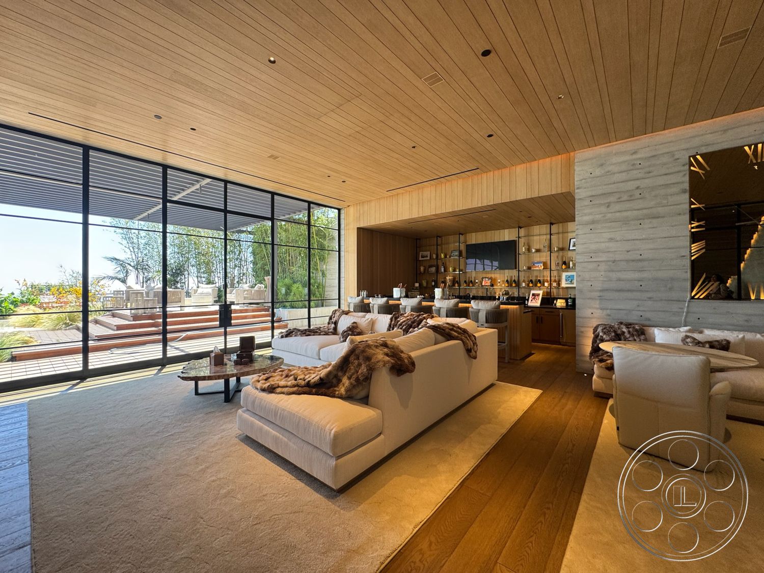 Star Villa - neutral color palette, open concept layout, minimalist furniture, textured wall panels, outdoor view, large floor-to-ceiling windows, contemporary coffee table, luxurious textiles, hardwood living room floors, modern interior design, natural light-filled space, concrete feature wall, exposed wood ceiling, cozy living room seating