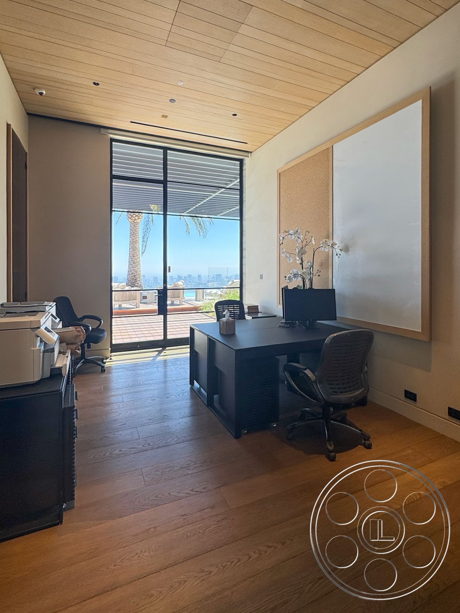 Star Villa - natural light, hardwood flooring, large glass sliding doors, plants as decor, city skyline view, black office chair, modern office space, minimalist desk design, light wood ceiling planks, cork board wall