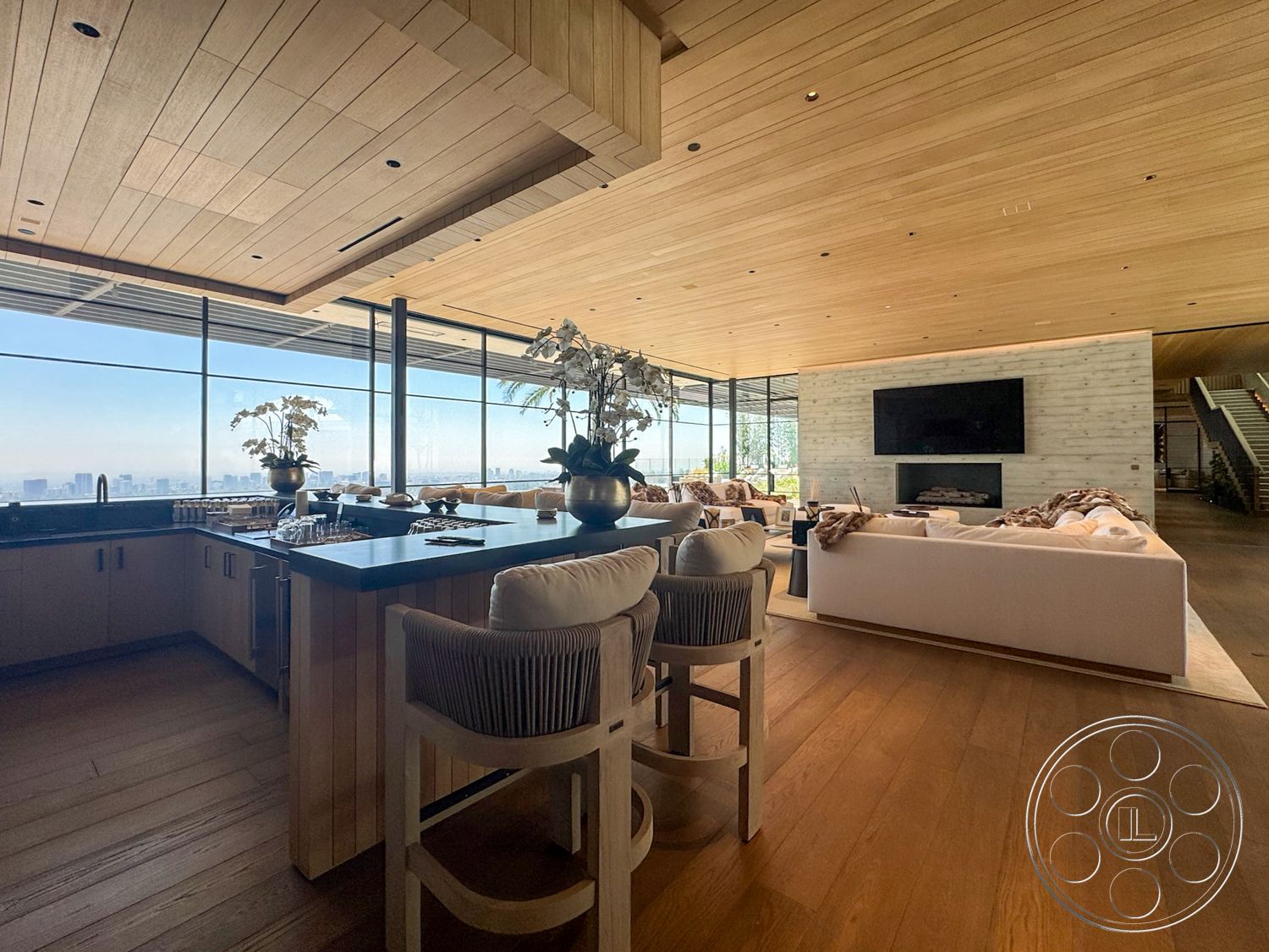 Star Villa - hardwood flooring, minimalist design, glass sliding doors, floor-to-ceiling windows, open-concept living space, wood ceiling panels, urban skyline view, stone feature wall, black granite kitchen countertop, exposed wood beam ceiling, modern fireplace wall, light wood kitchen cabinetry