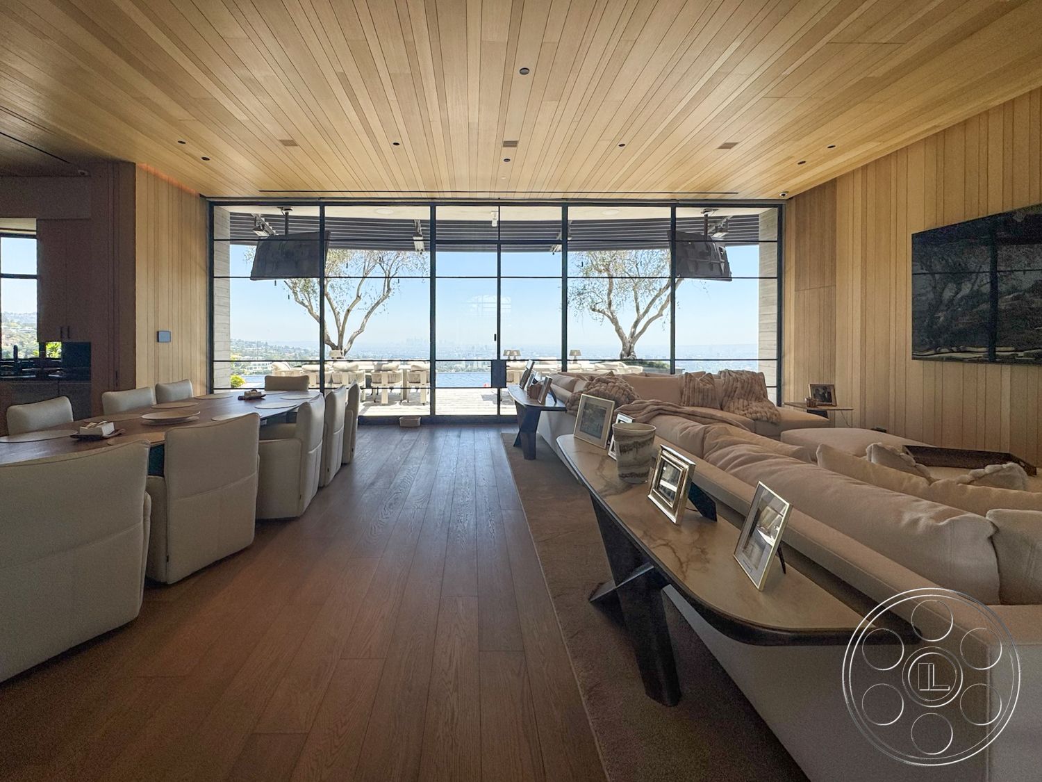 Star Villa - neutral color palette, exterior, minimalist design, contemporary artwork, light hardwood flooring, upholstered dining chairs, landscape view, floor-to-ceiling windows, glass dining table, open-concept living space, modern sectional sofa, natural light flooding in, wood plank ceiling, stone patio area