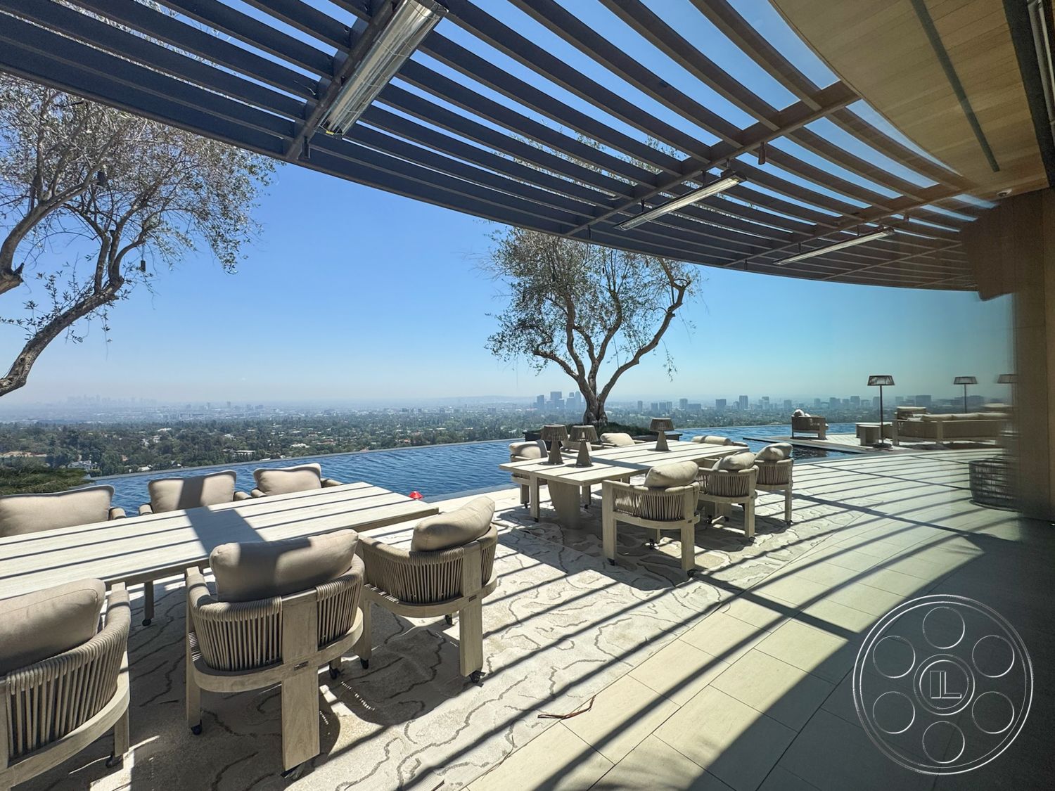 Star Villa - exterior, upholstered dining chairs, outdoor seating area, landscape view, city skyline view, glass wall, sunny environment, concrete patio flooring, wood beam pergola, rectangular outdoor dining table, infinity pool edge