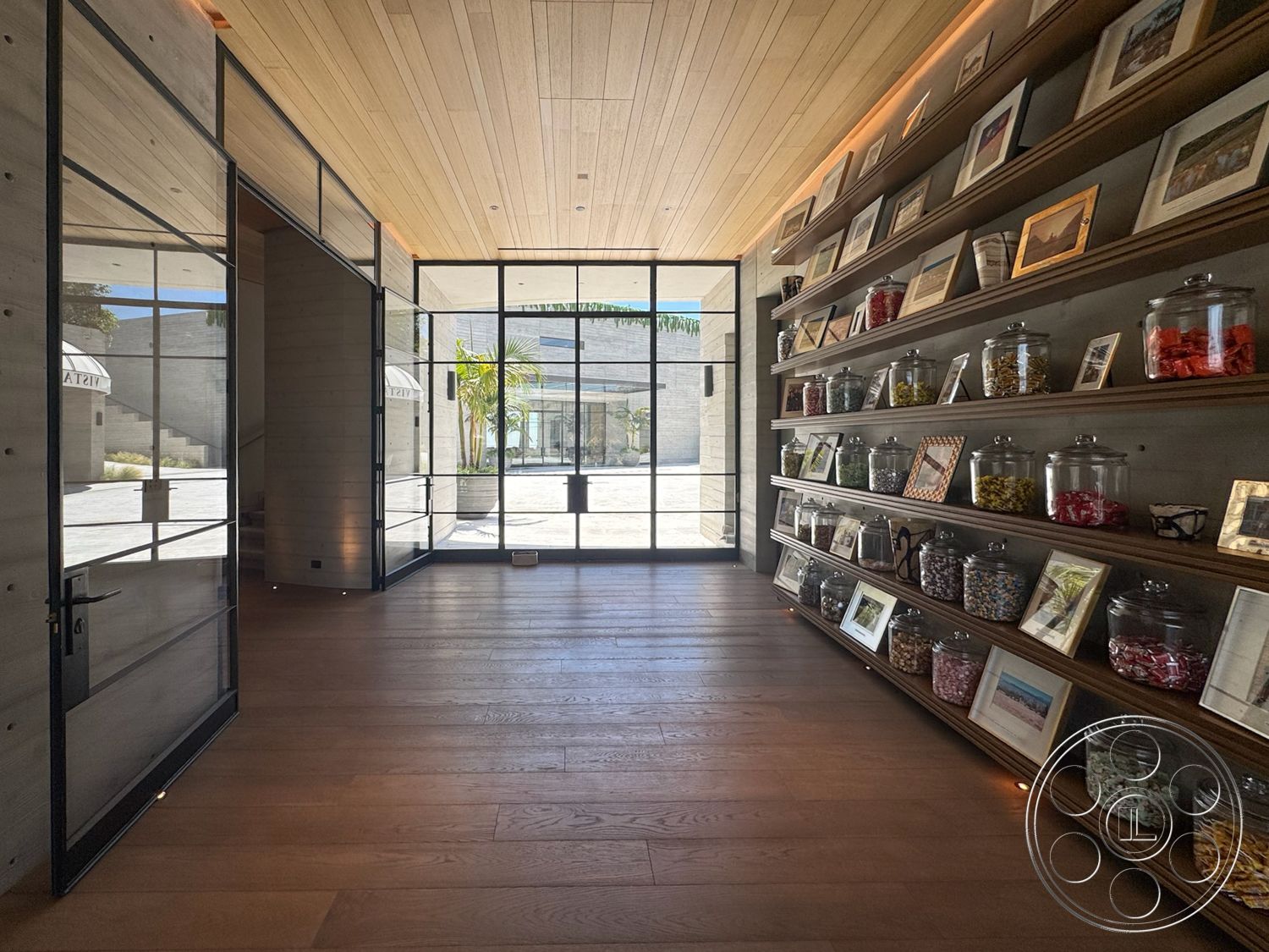 Star Villa - open space layout, minimalist design elements, concrete walls, modern architectural style, interior hardwood flooring, exterior glass entrance doors, built-in wooden shelving, exposed wood ceiling, landscaped outdoor view, natural light source, steel frame windows, glass jars display, picture frame wall displays