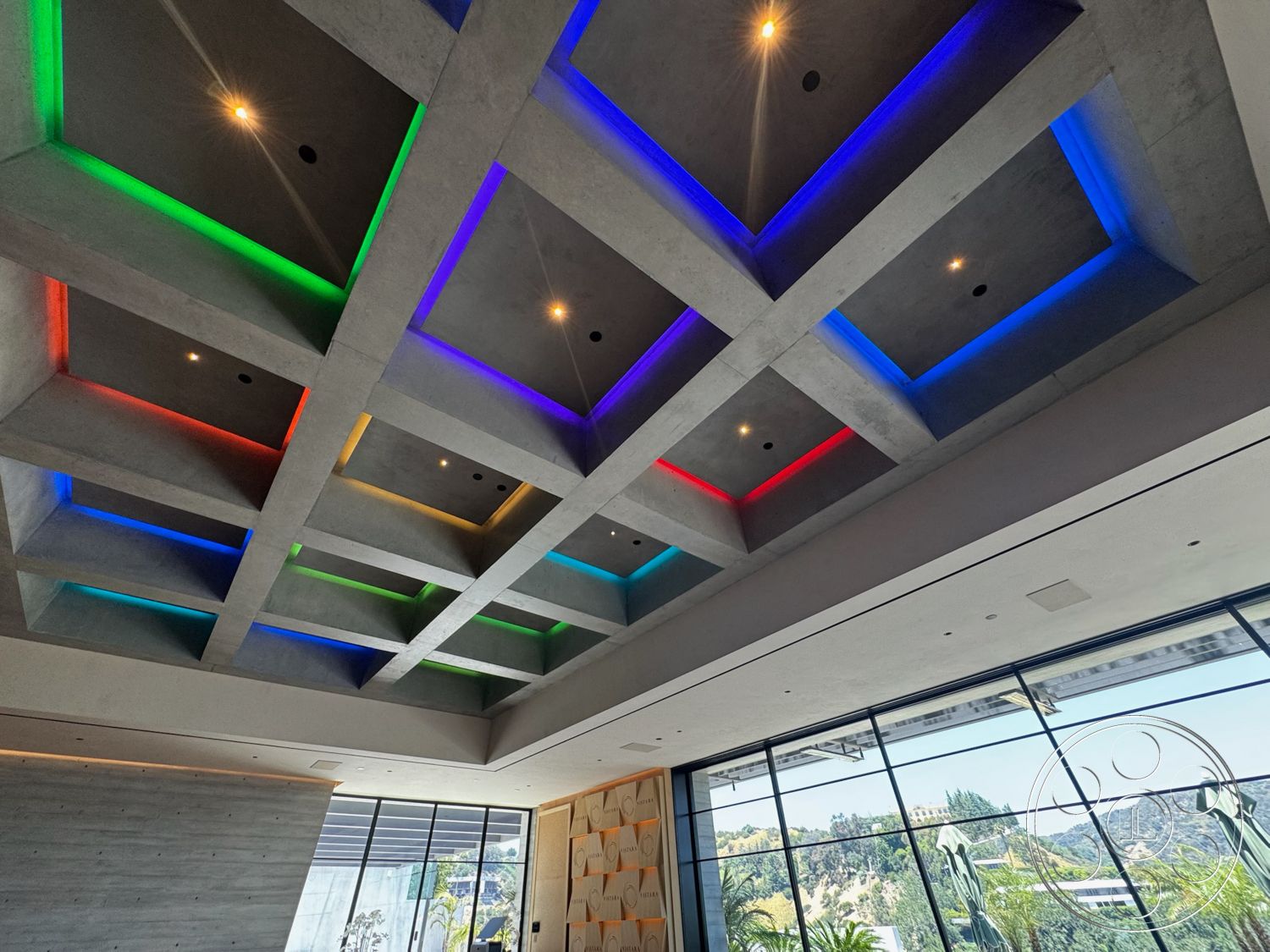 Star Villa - modern architectural style, mountain view, textured concrete wall, recessed ceiling lights, floor-to-ceiling glass windows, exposed concrete coffered ceiling, colorful LED backlighting